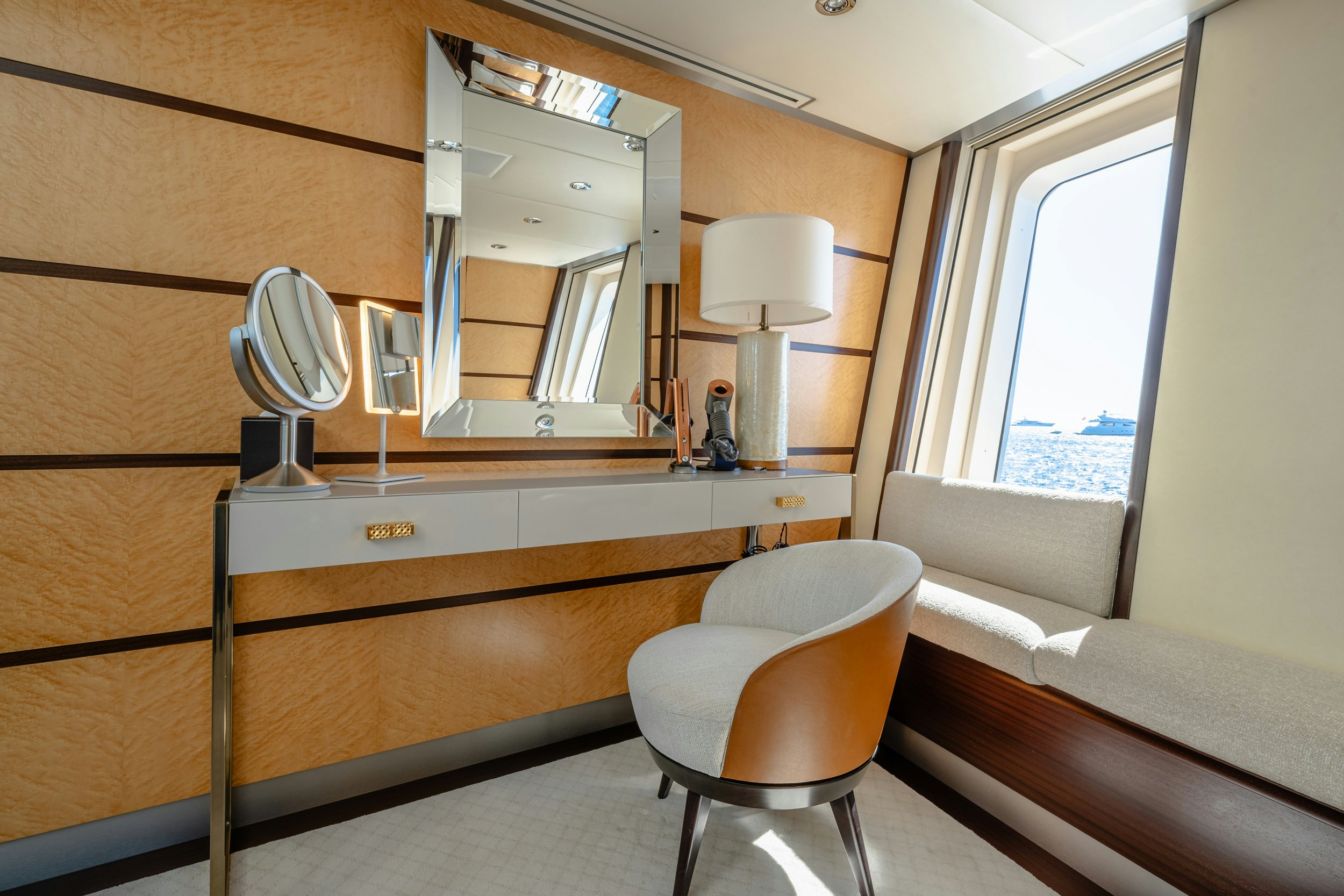 a room with a mirror and a chair aboard GLADIATOR Yacht for Charter