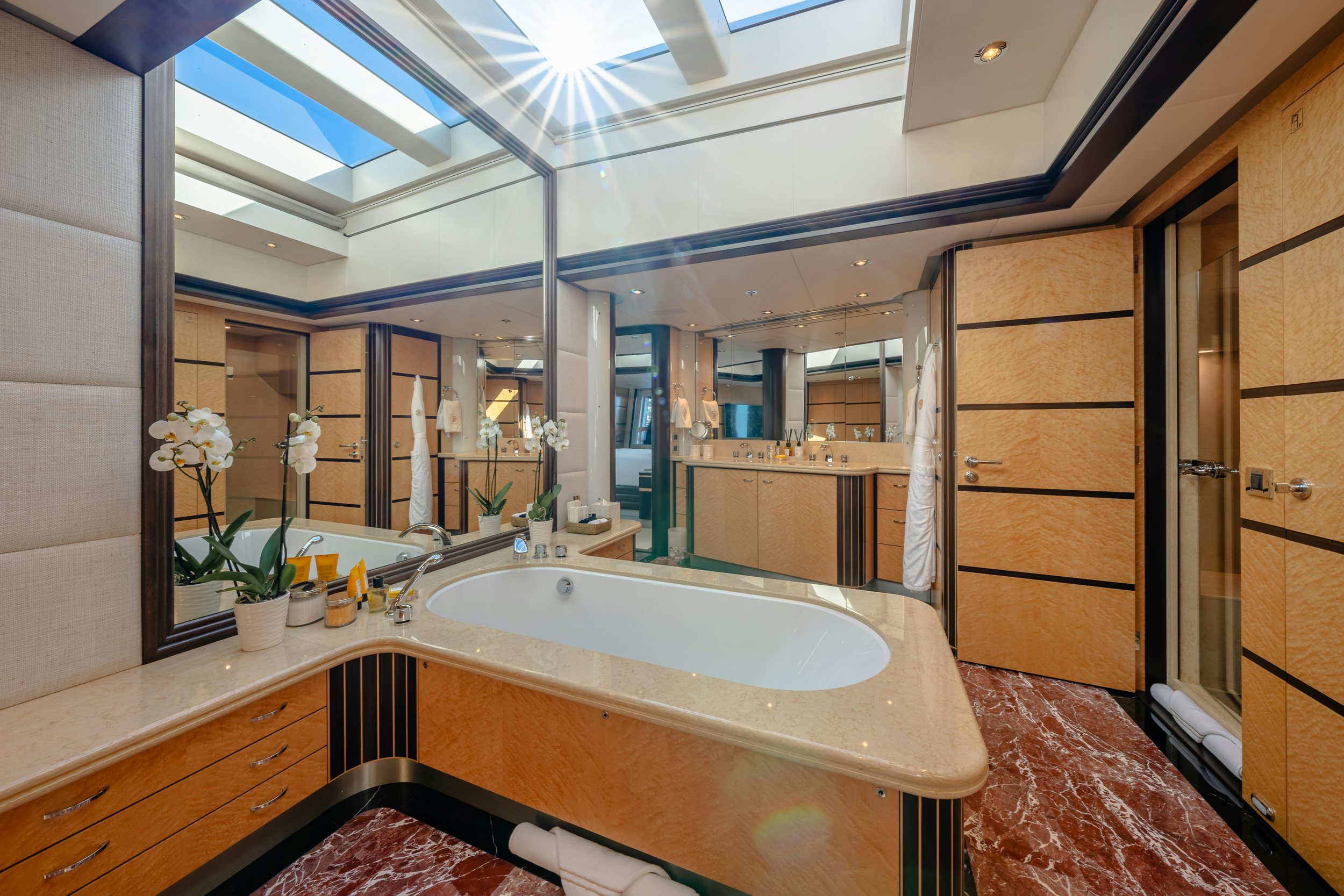 a bathroom with a large mirror aboard GLADIATOR Yacht for Charter