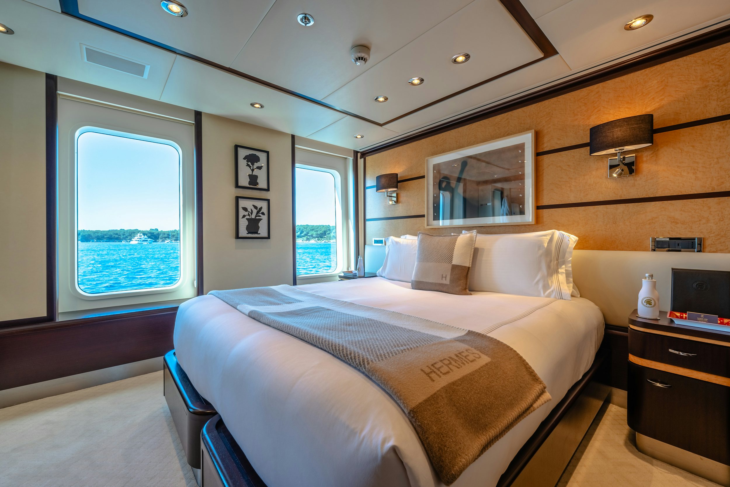 a bedroom with a bed and a desk aboard GLADIATOR Yacht for Charter