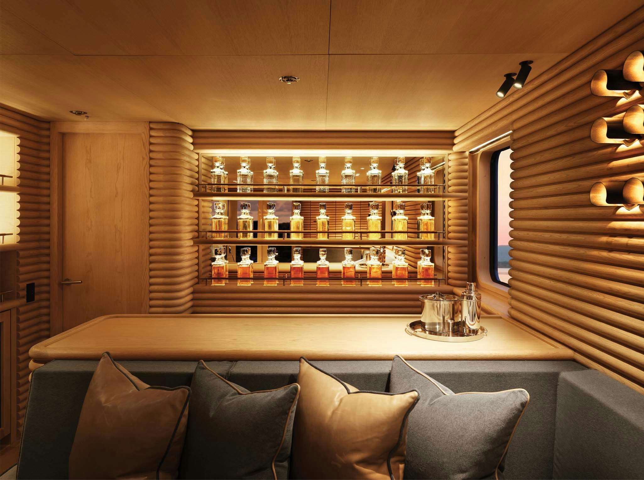 a room with a couch and a shelf with glasses aboard RH THREE Yacht for Charter