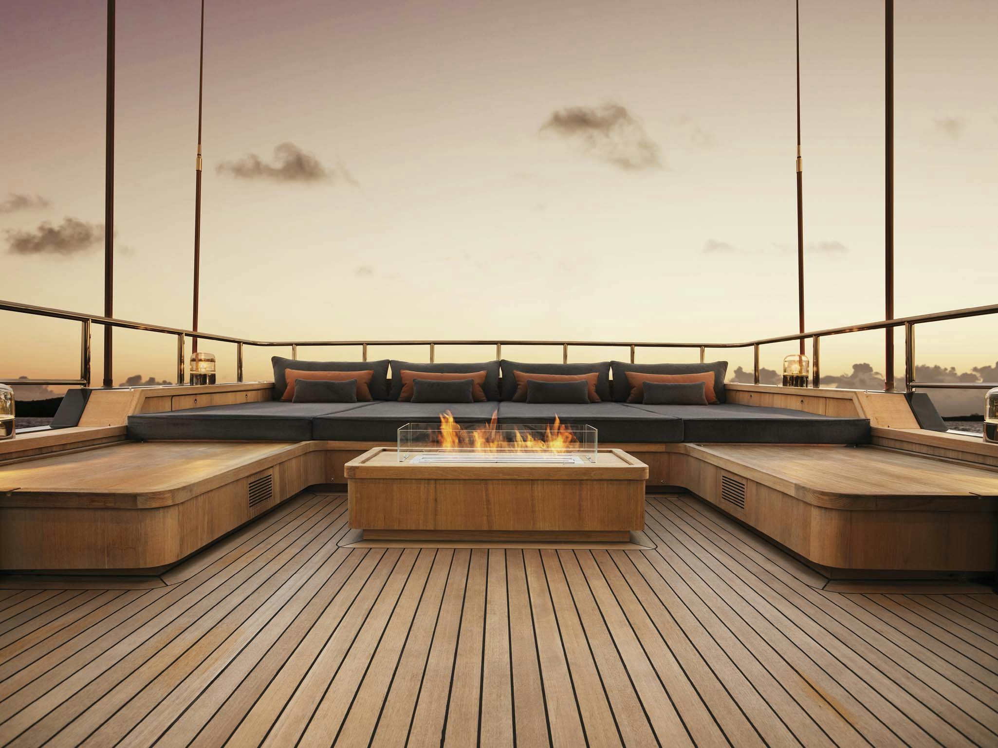 a wood deck with a fire pit aboard RH THREE Yacht for Charter