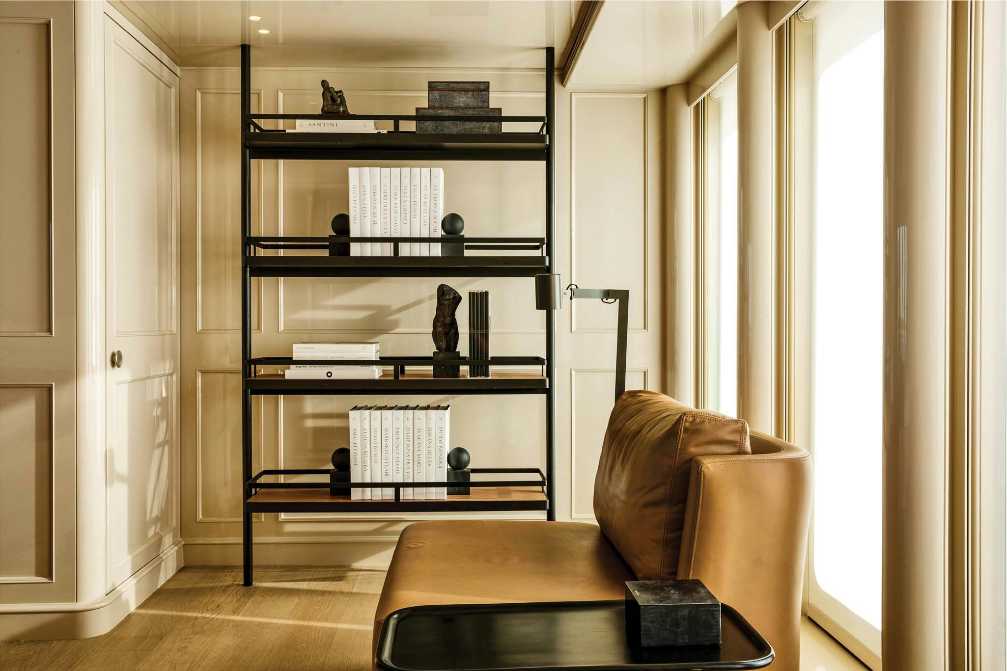 a room with a bookcase and a couch aboard RH THREE Yacht for Charter