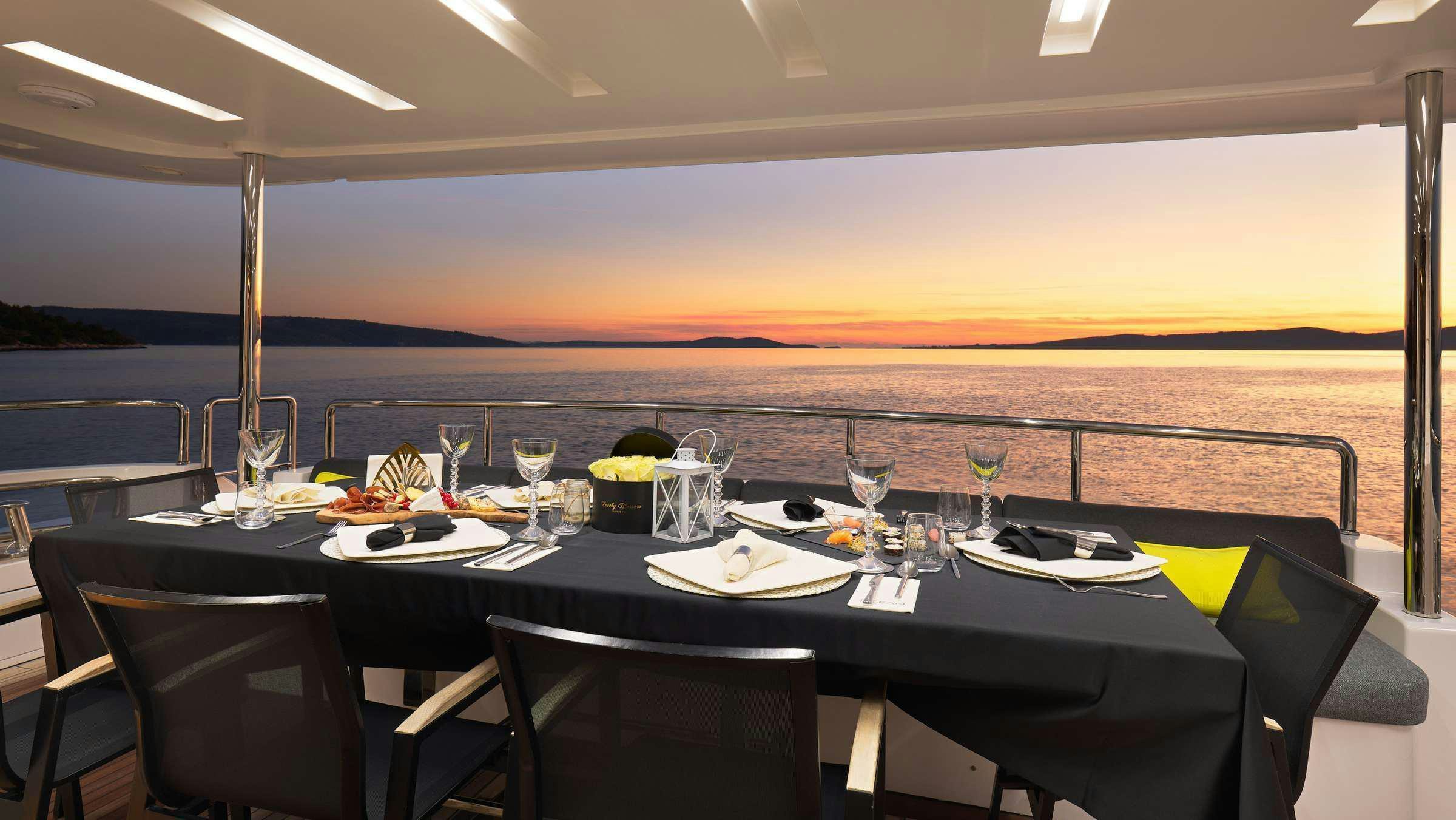a table with plates and glasses on it aboard OCEAN DRIVE Yacht for Charter