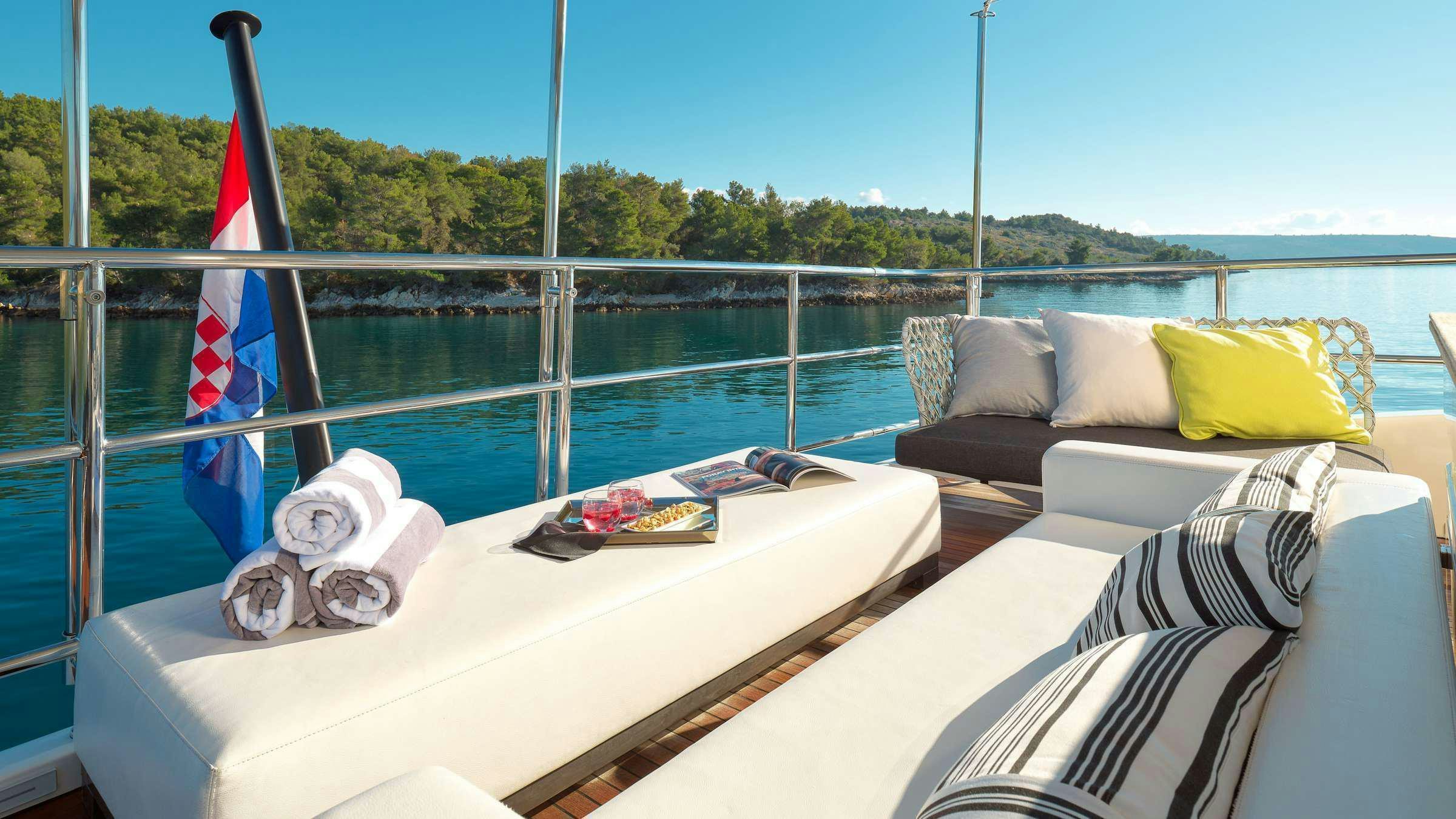 a bed on a balcony overlooking a body of water aboard OCEAN DRIVE Yacht for Charter