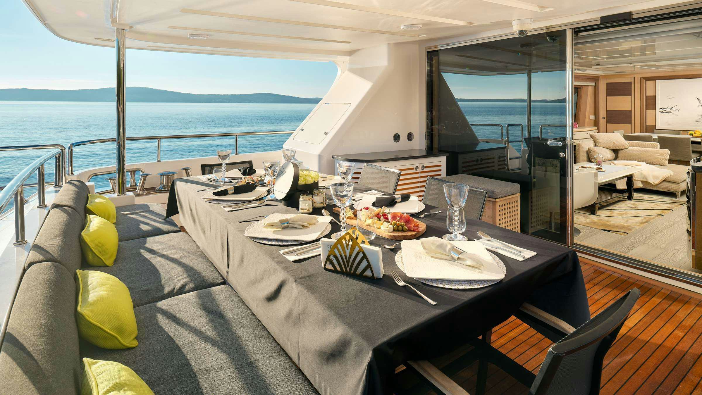 a table with plates and food on it aboard OCEAN DRIVE Yacht for Charter