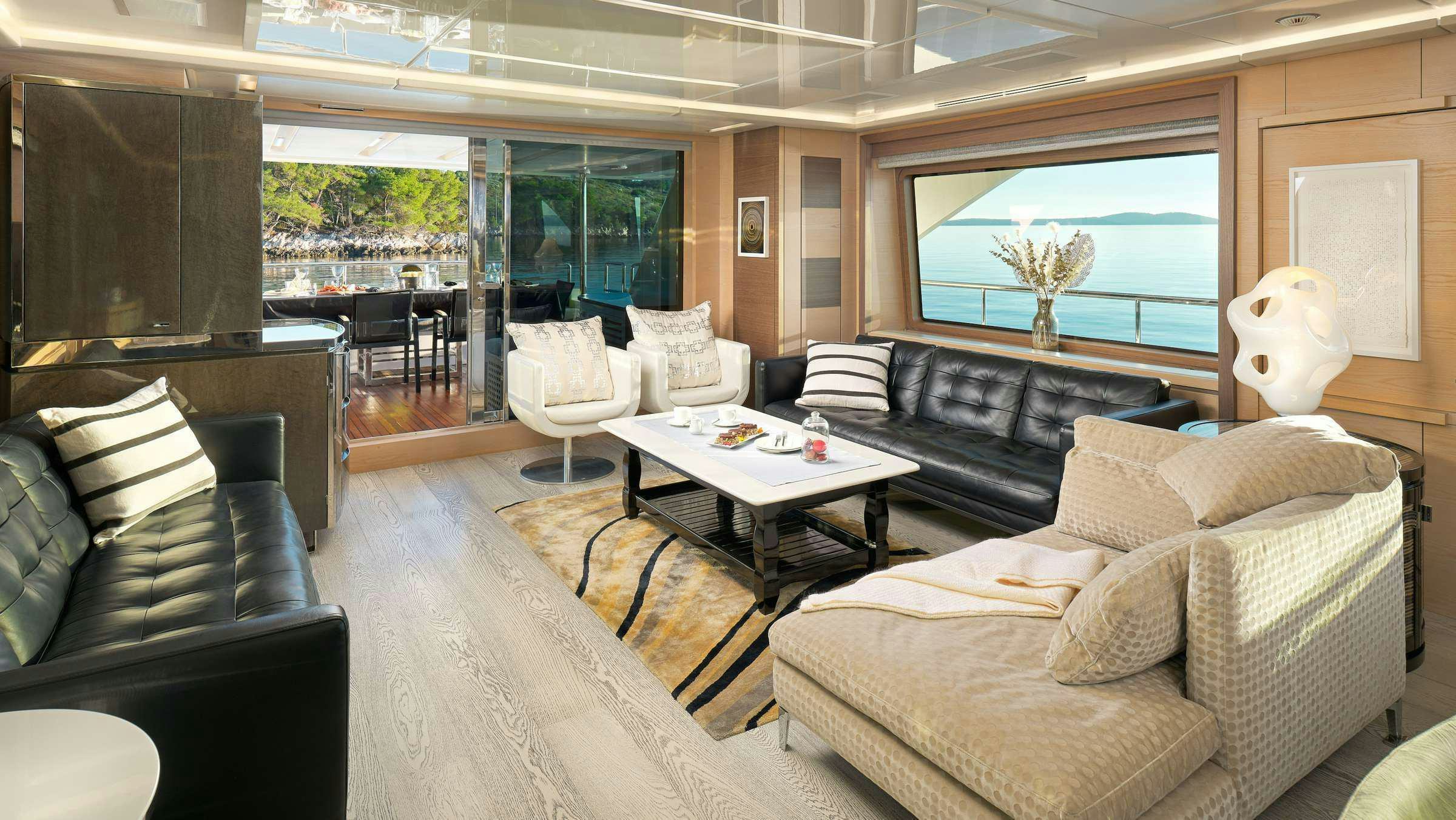 a living room with leather couches and a coffee table aboard OCEAN DRIVE Yacht for Charter