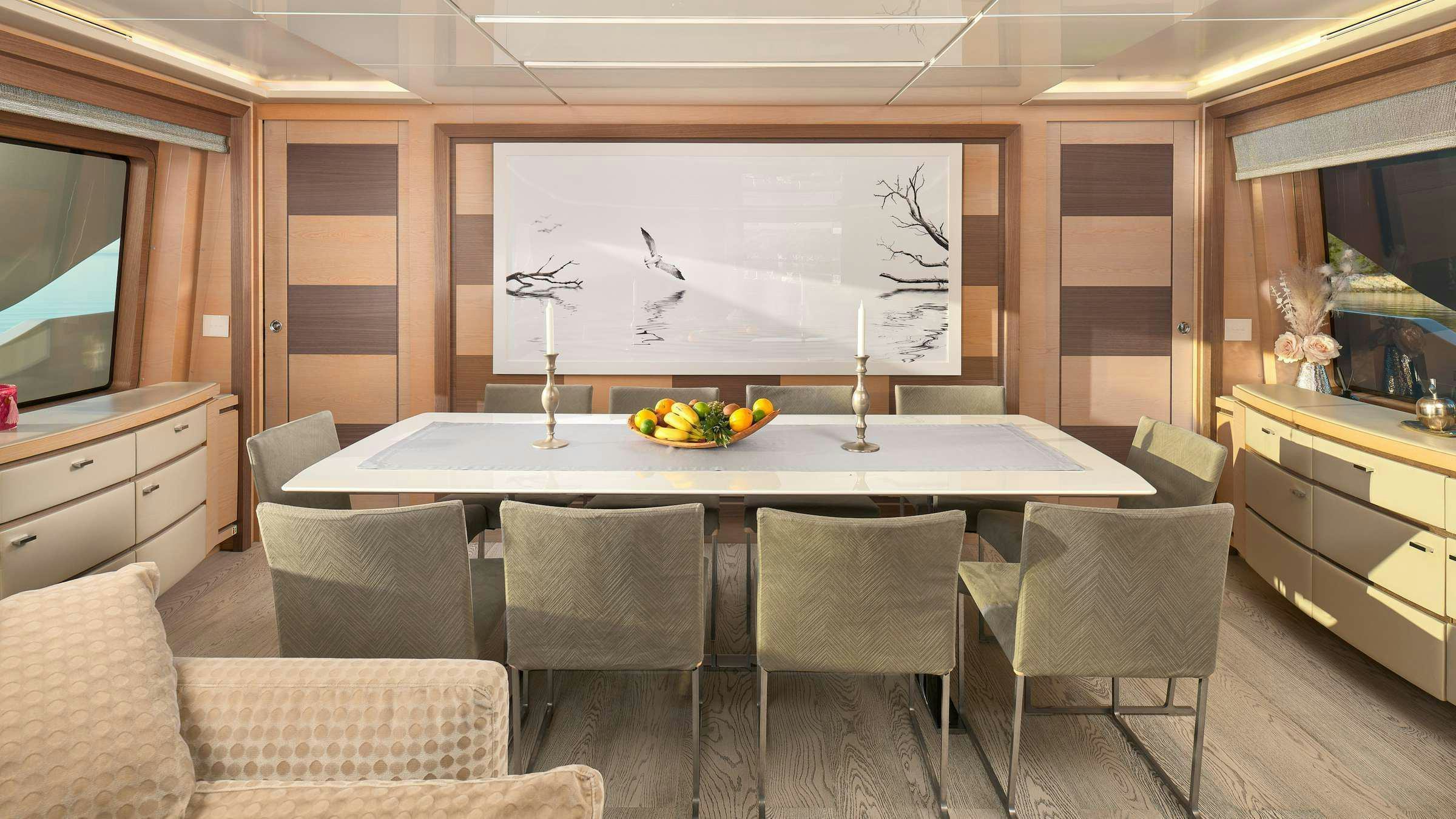 a room with a table chairs and a large screen aboard OCEAN DRIVE Yacht for Charter