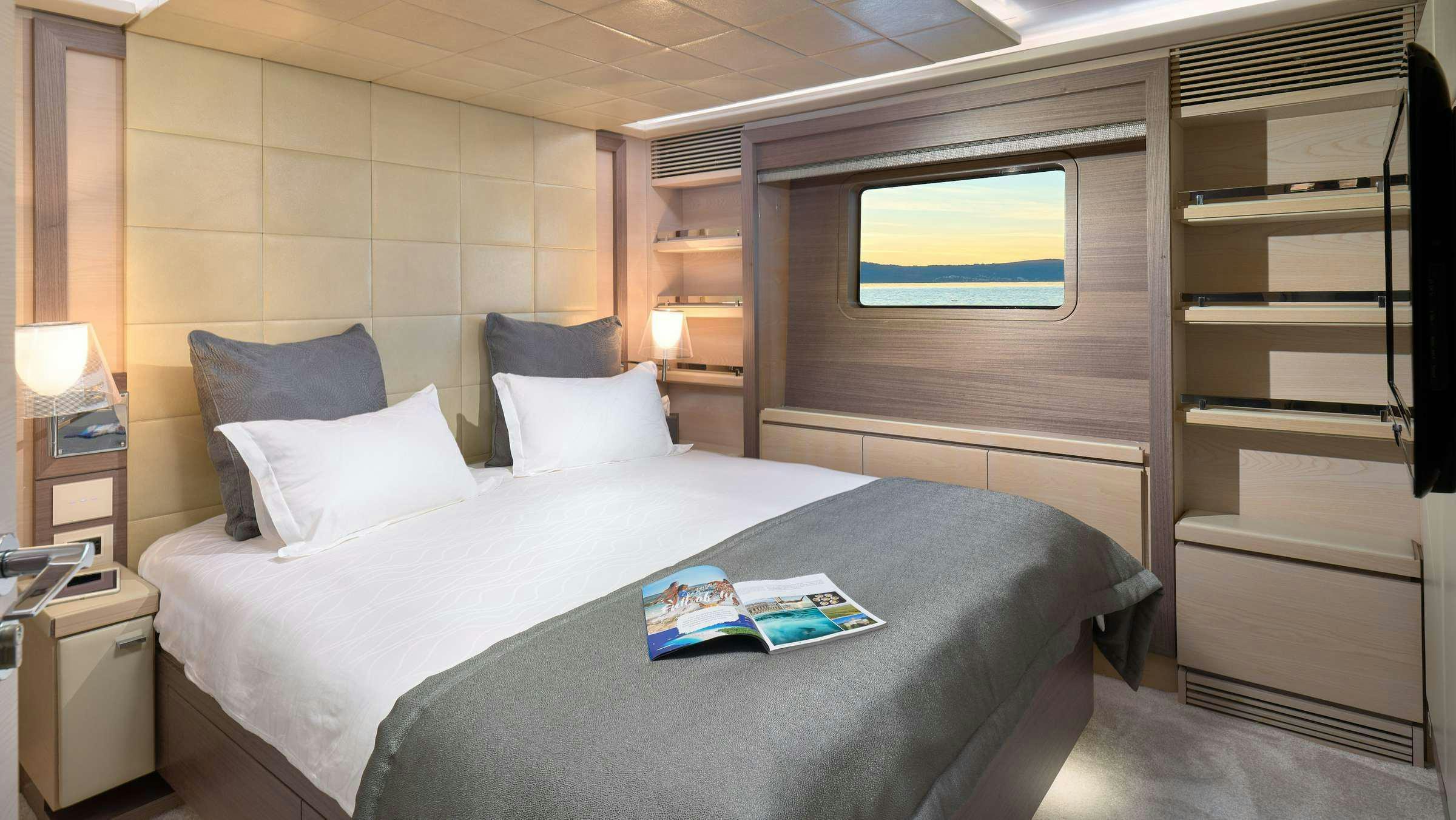 a bed with a white sheet and pillows aboard OCEAN DRIVE Yacht for Charter