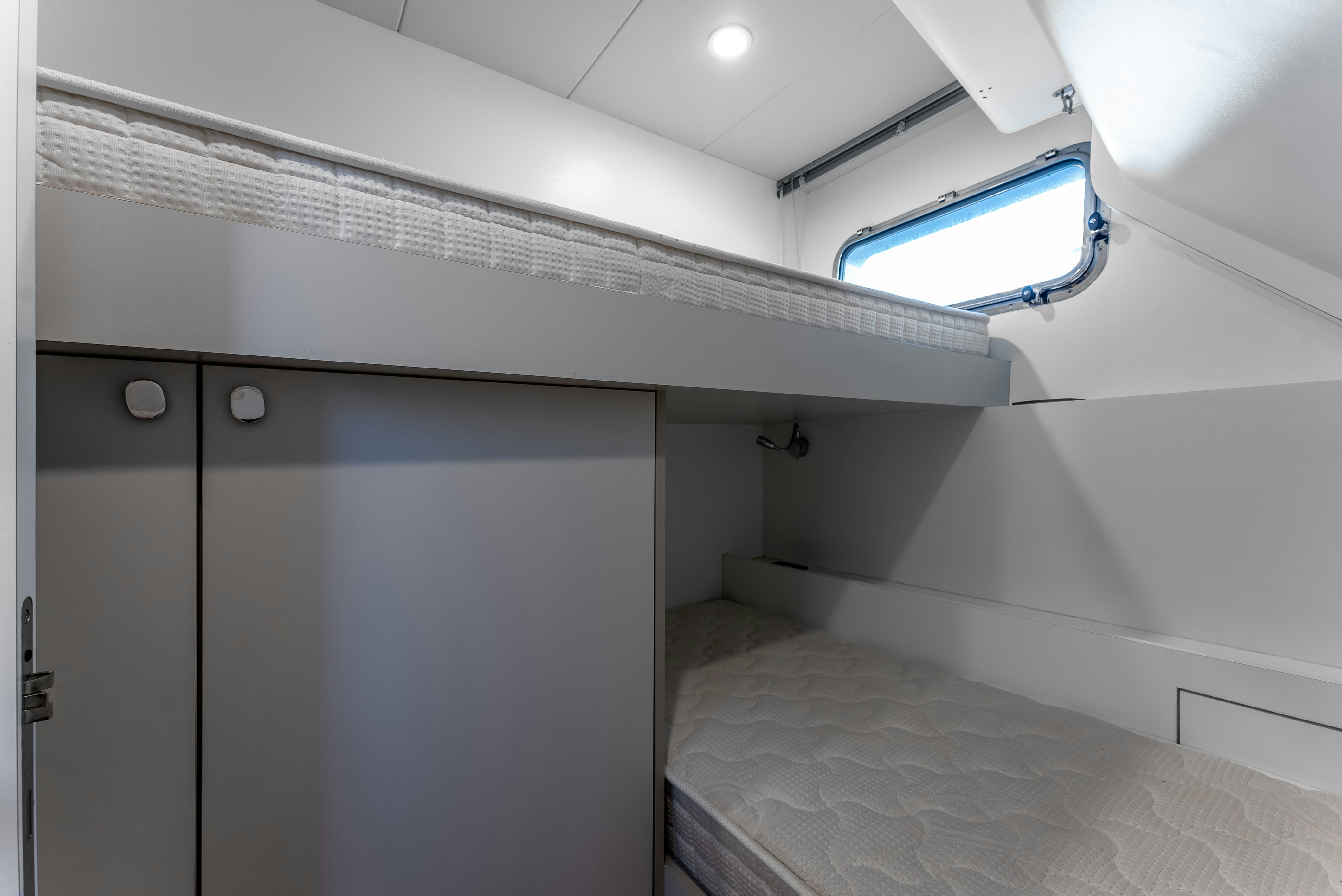 a room with a bed and a window aboard LITTLE MERMAID Yacht for Sale