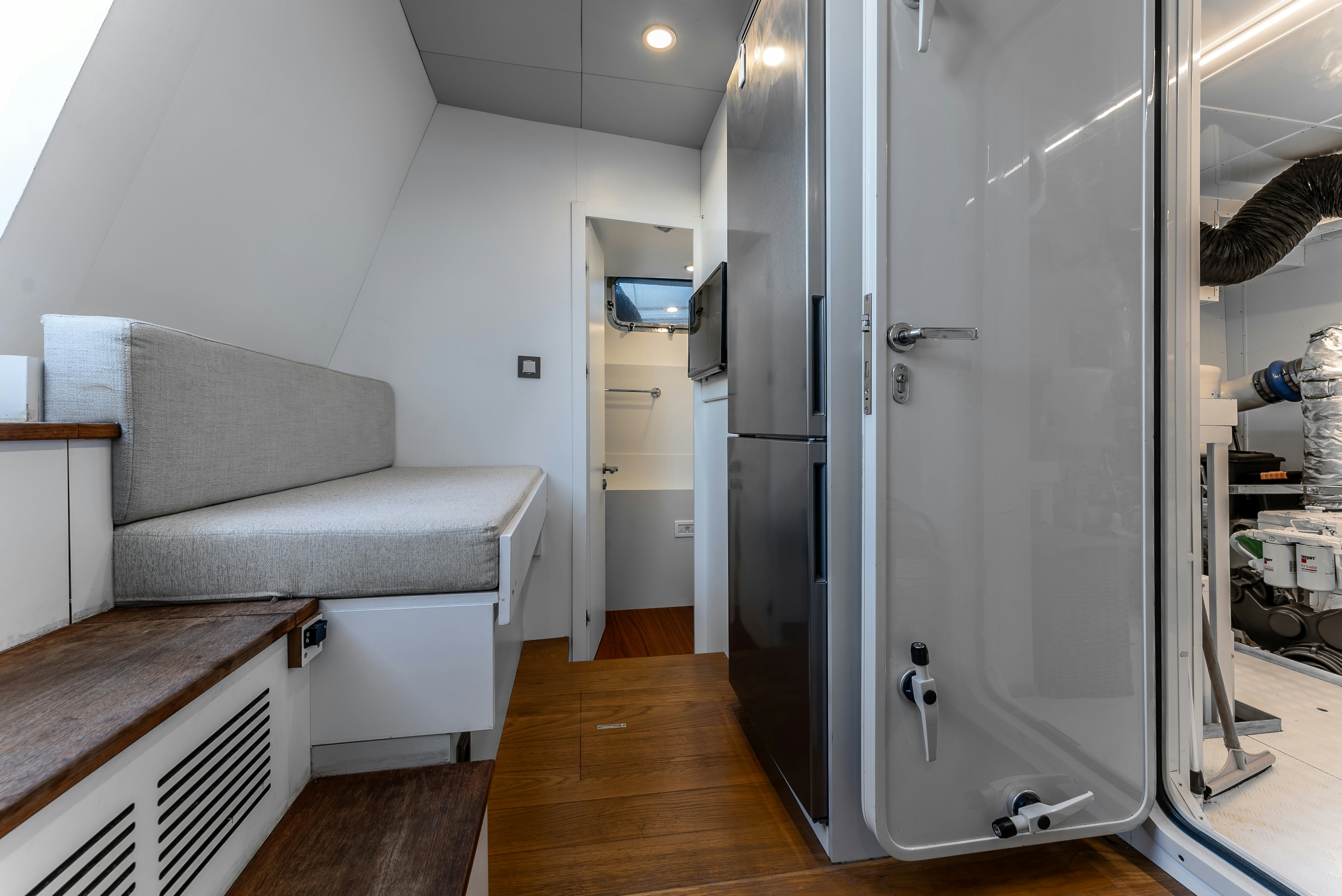 a living room with a couch and a large glass door aboard LITTLE MERMAID Yacht for Sale