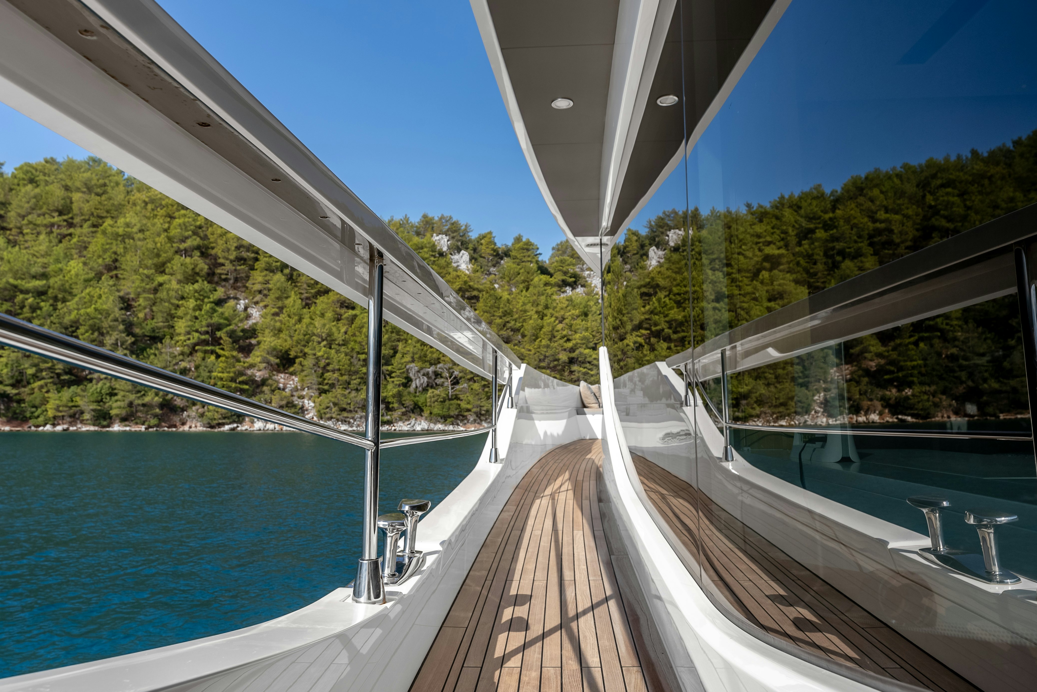 a long white bridge over a body of water with Sundial Bridge at Turtle Bay in the background aboard LITTLE MERMAID Yacht for Sale