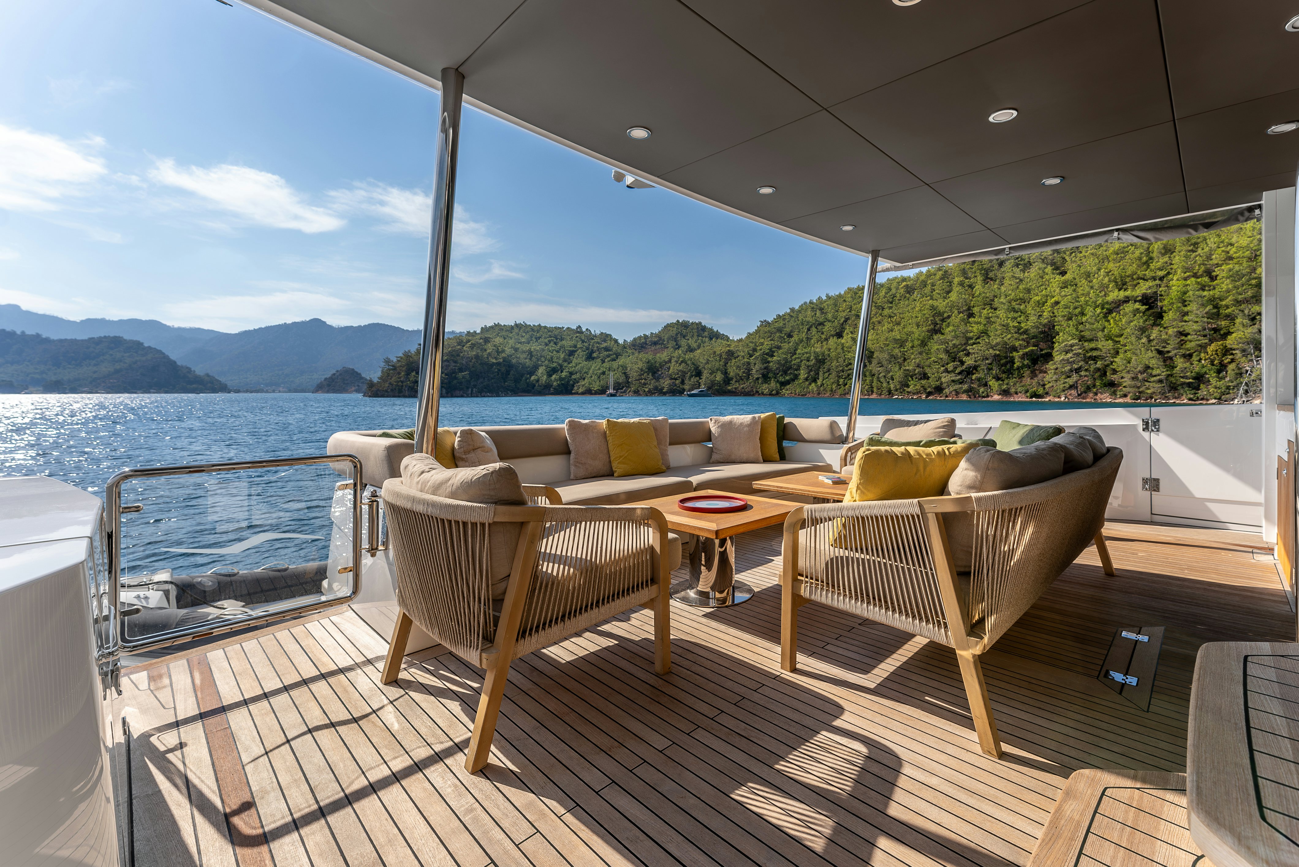 a deck with a table and chairs on it aboard LITTLE MERMAID Yacht for Sale