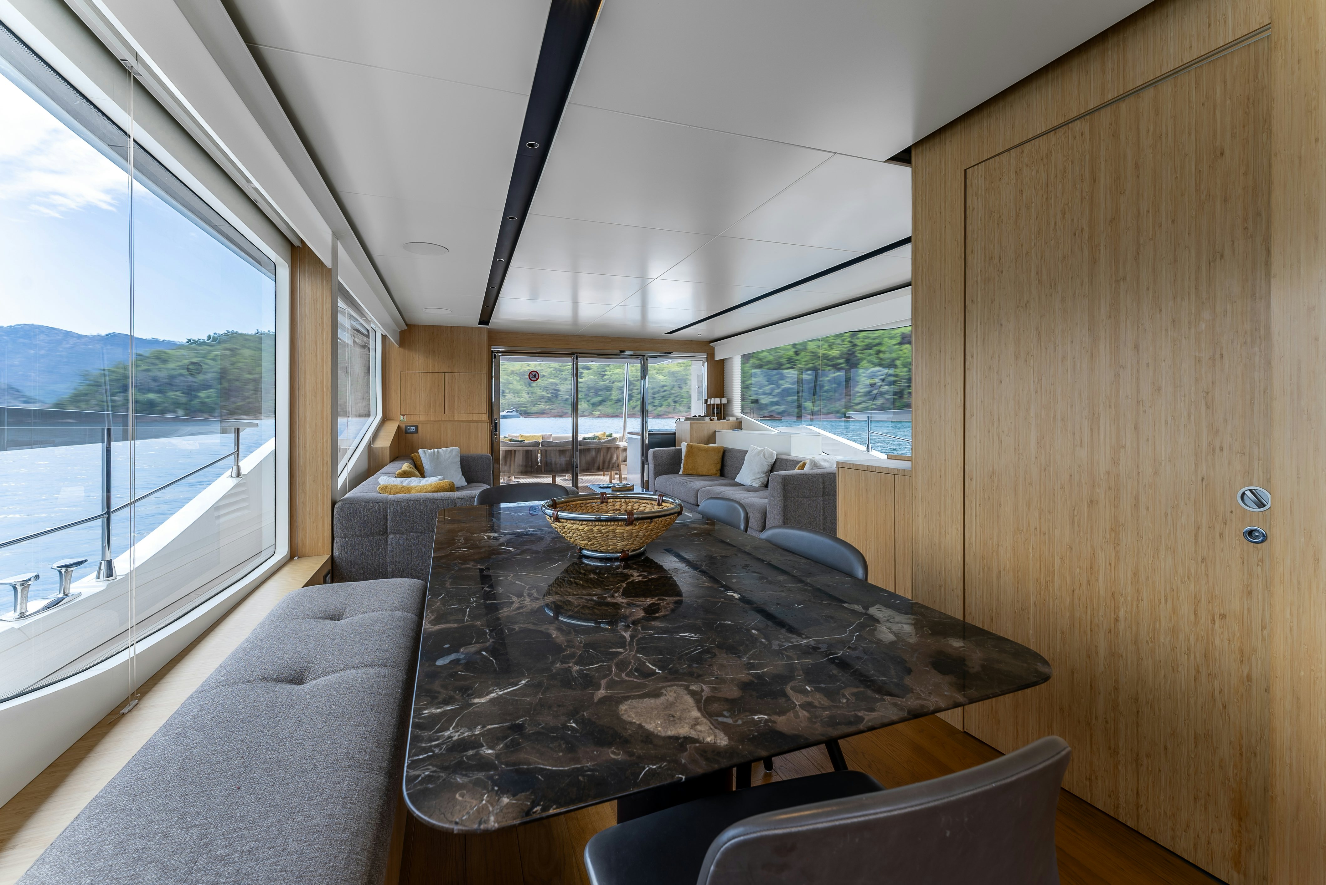 a large living room with a large table and a large window aboard LITTLE MERMAID Yacht for Sale