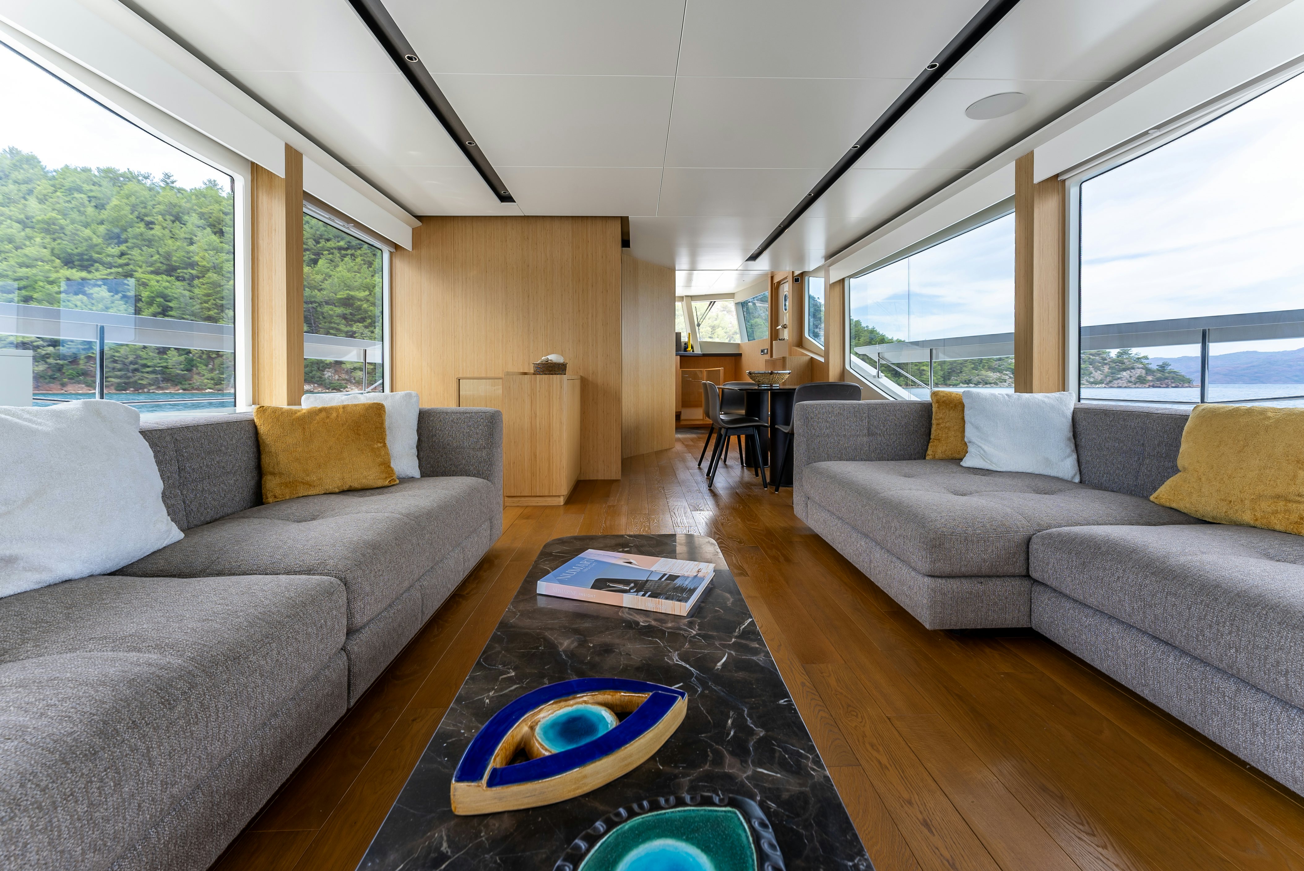 a living room with a couch and a coffee table aboard LITTLE MERMAID Yacht for Sale
