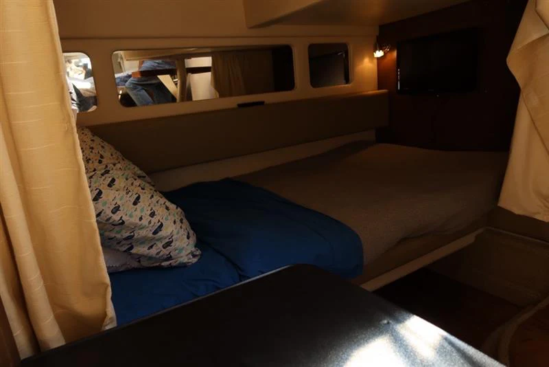 a bed with a blue comforter aboard BON VOYAGE Yacht for Sale