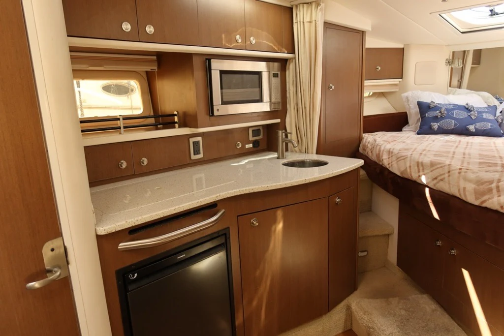 a small bedroom with a small bed aboard BON VOYAGE Yacht for Sale