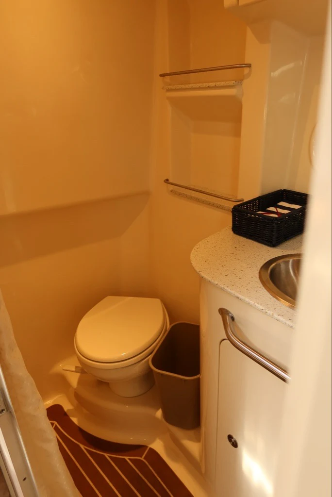 a small bathroom with a toilet aboard BON VOYAGE Yacht for Sale