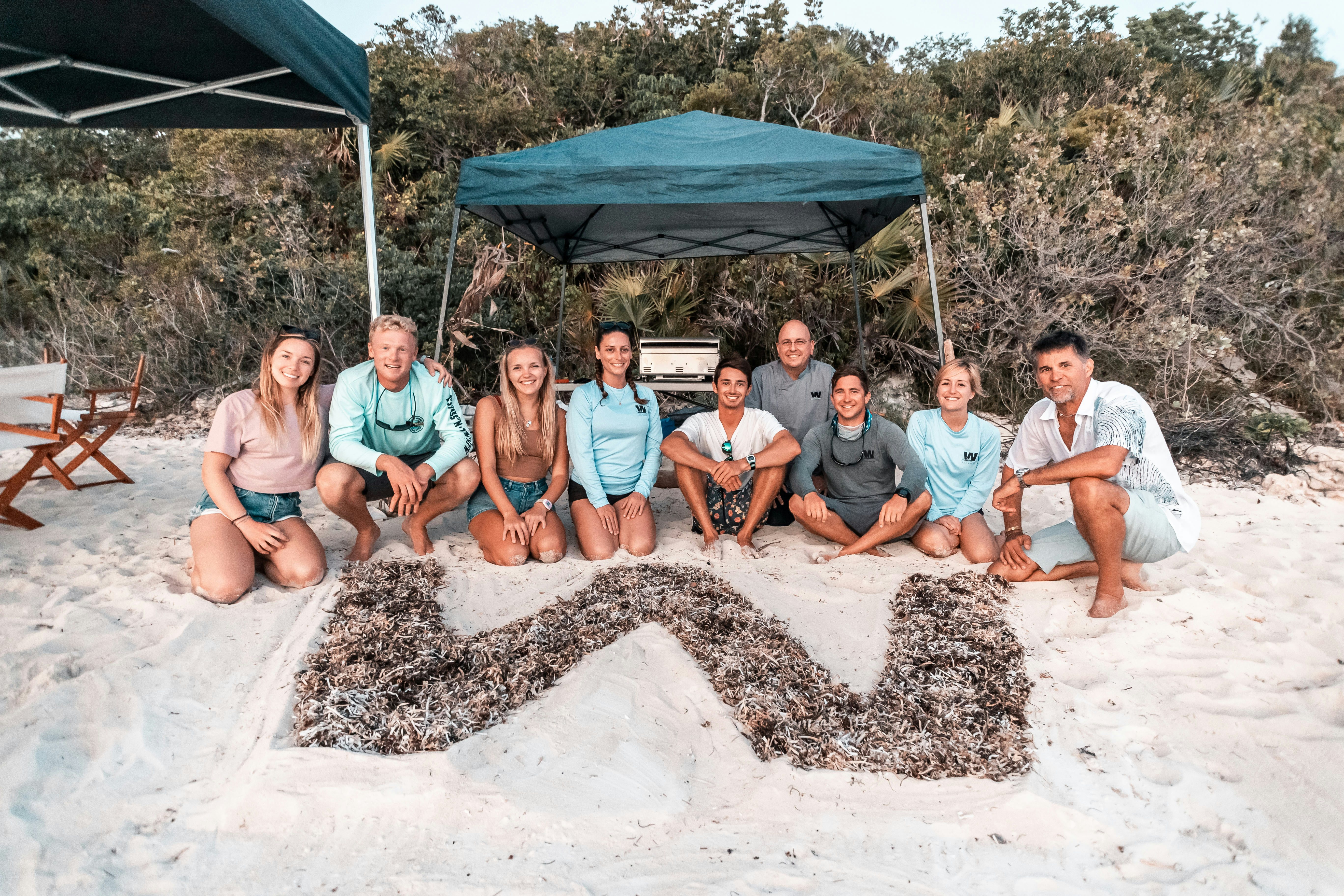 a group of people sitting on a sandbox aboard W Yacht for Charter