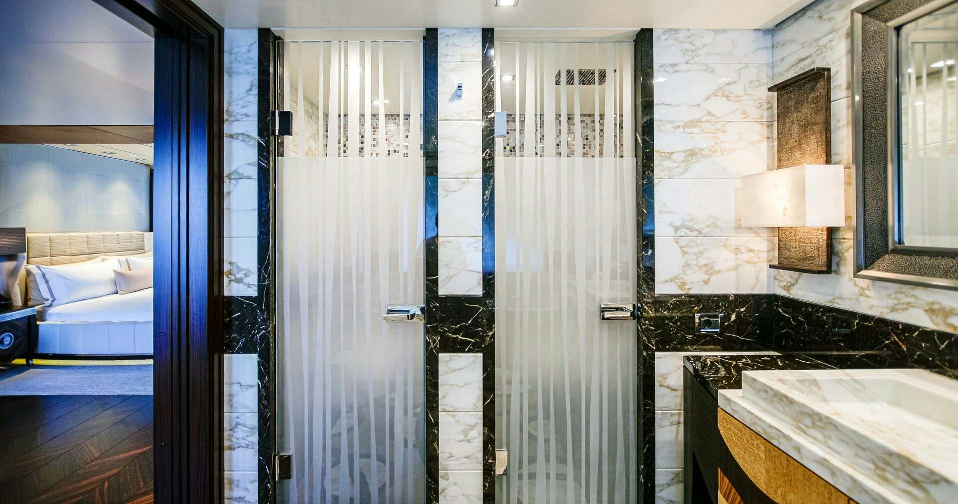 a bathroom with a tub and shower aboard W Yacht for Charter