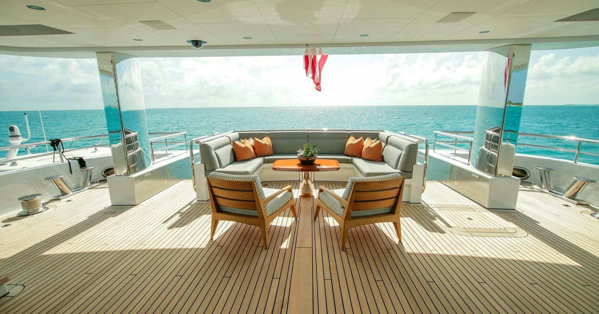 a room with a table and chairs on a deck aboard W Yacht for Charter