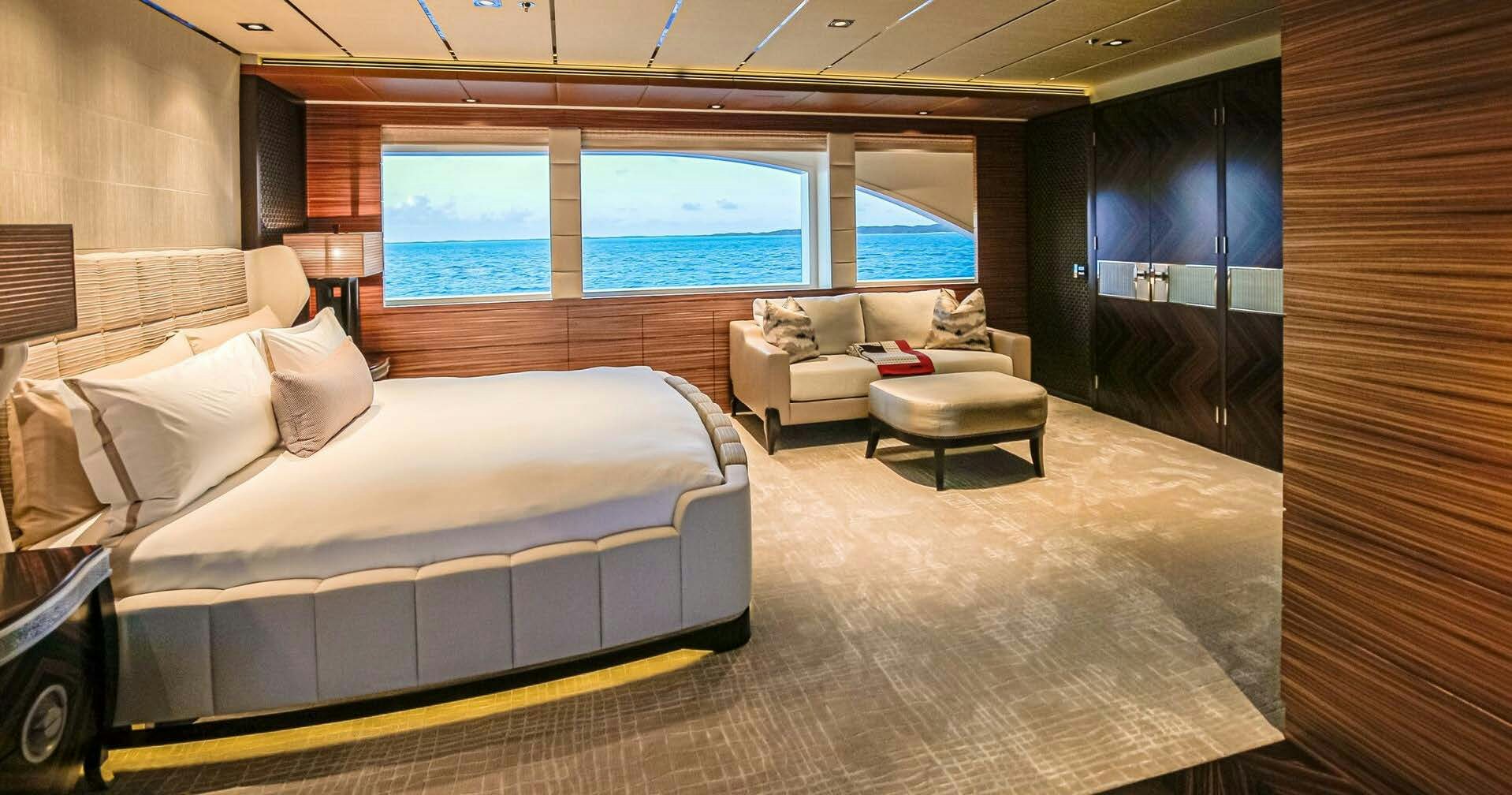 a room with a bed and a couch aboard W Yacht for Charter