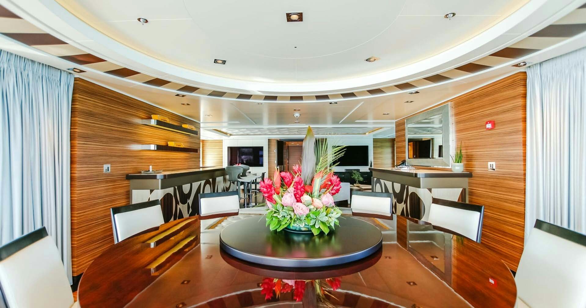 a room with a table and chairs aboard W Yacht for Charter