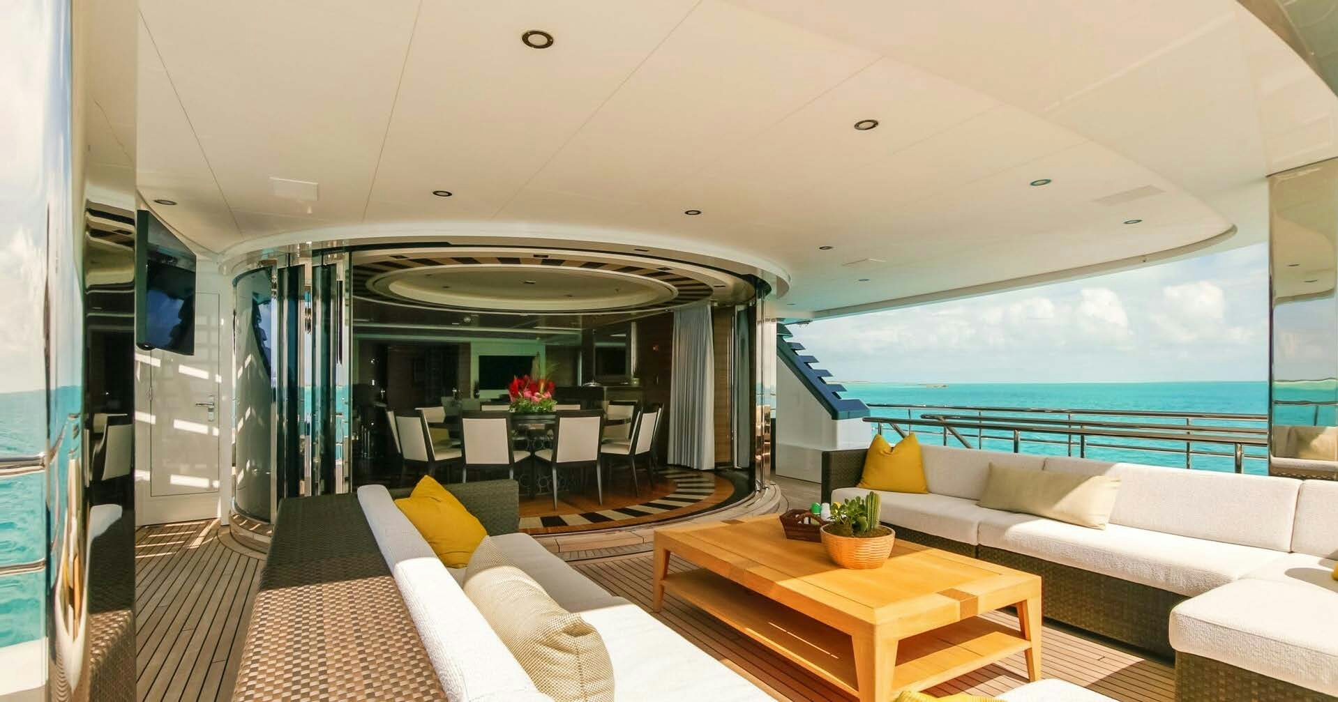 a room with a couch and a table and a large window aboard W Yacht for Charter