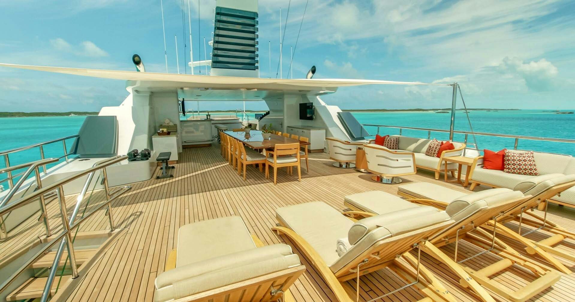 a deck with a large deck and chairs on it aboard W Yacht for Charter
