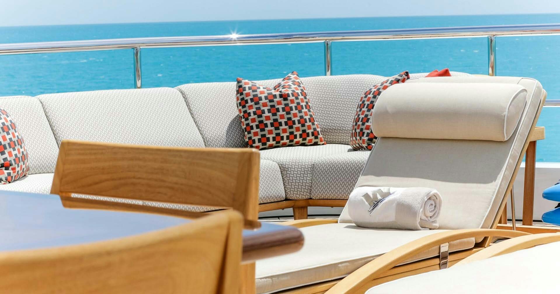 a couple of couches on a deck overlooking the ocean aboard W Yacht for Charter