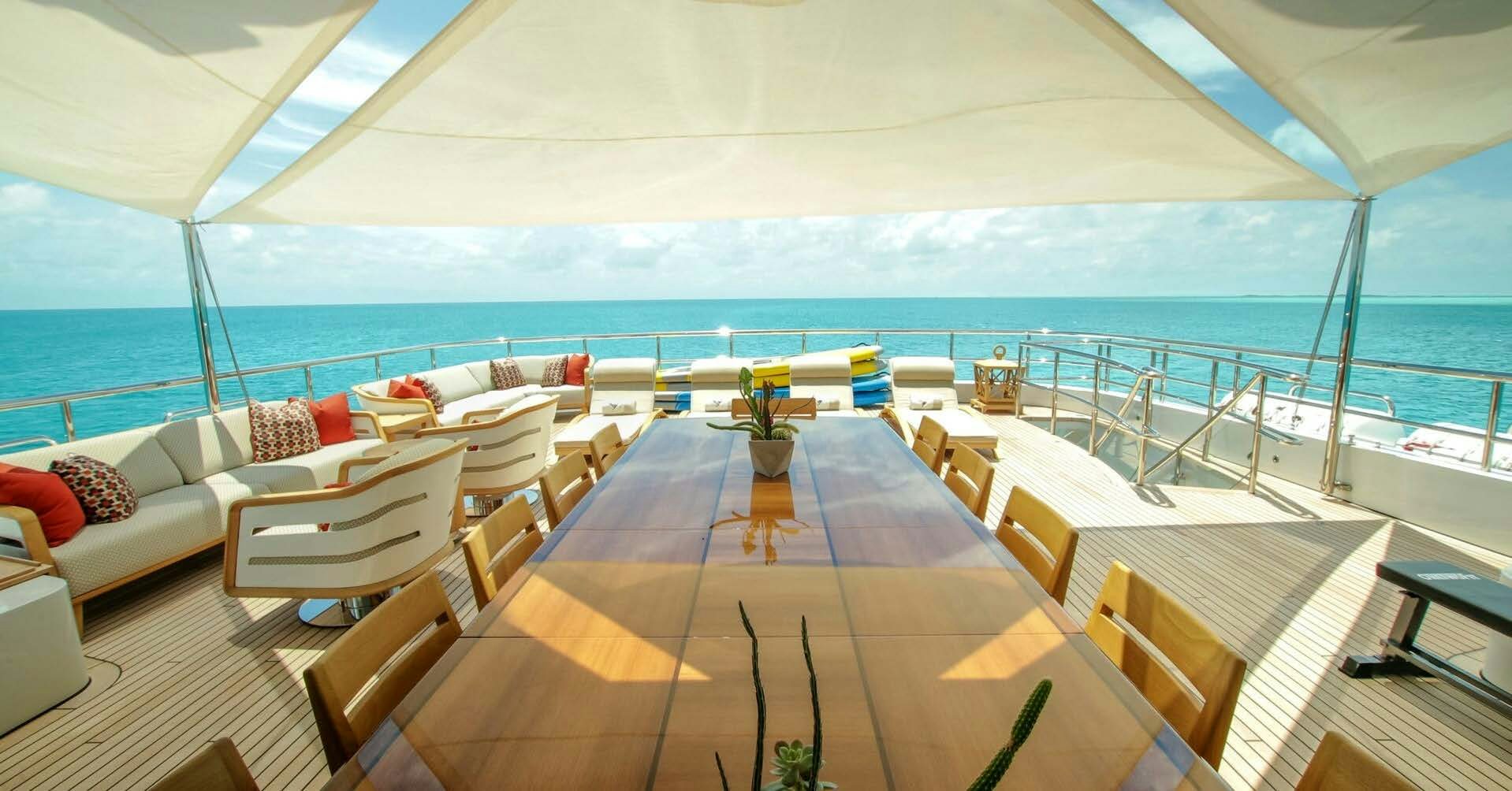 a large white tent with a table and chairs on it aboard W Yacht for Charter