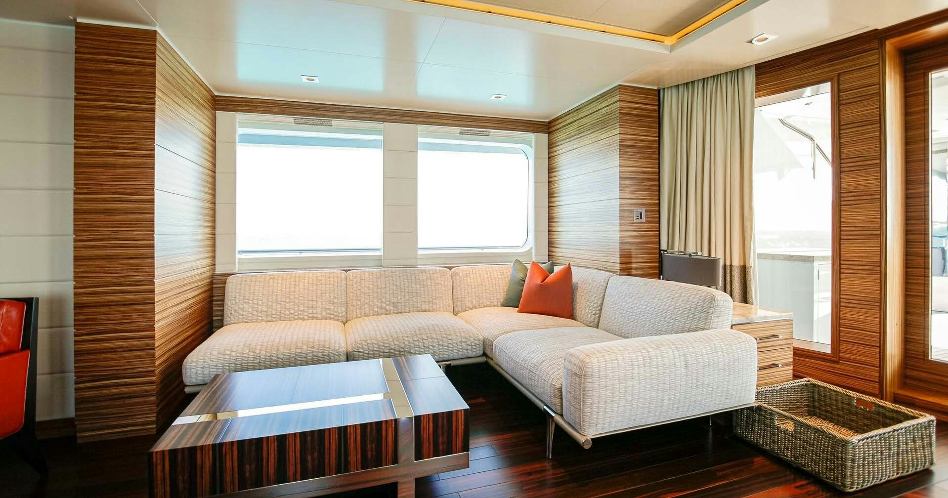 a room with a couch and a table aboard W Yacht for Charter