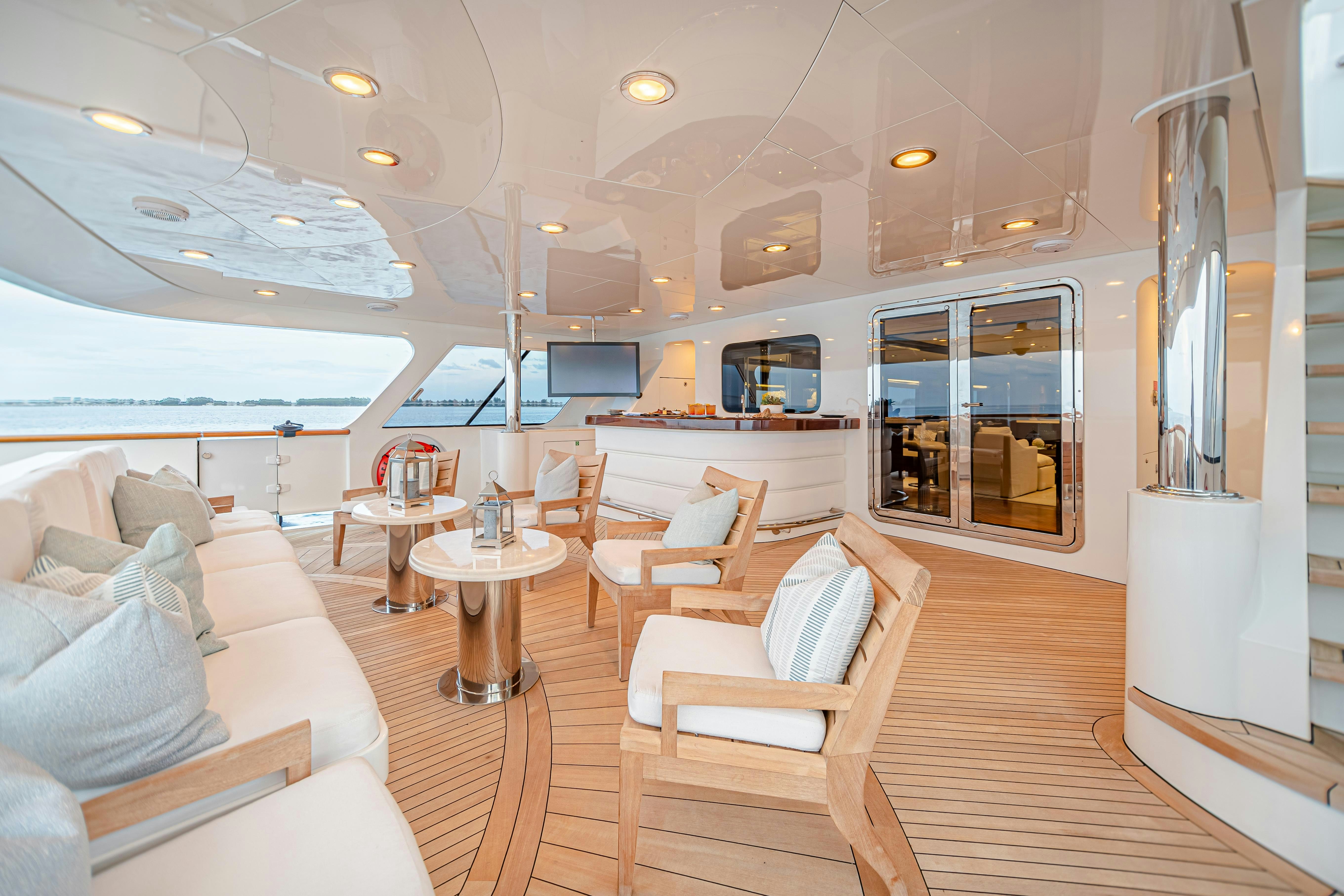 a room with a table chairs and a couch aboard MIRABELLA Yacht for Charter