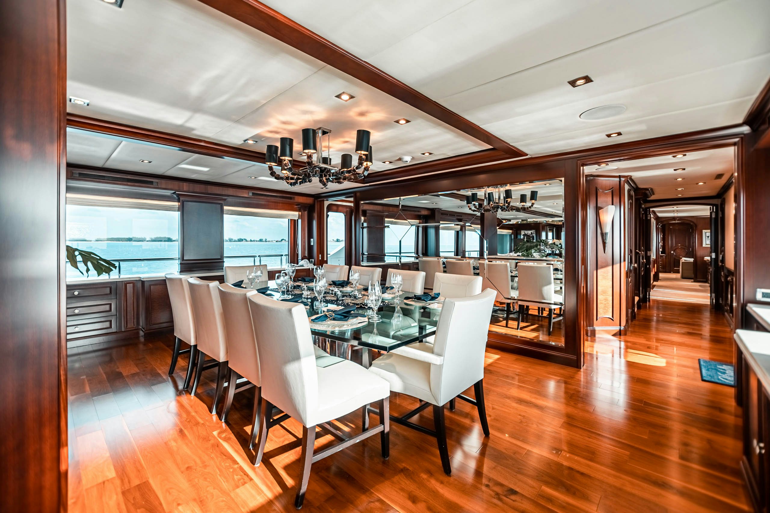 a room with tables and chairs aboard MIRABELLA Yacht for Charter