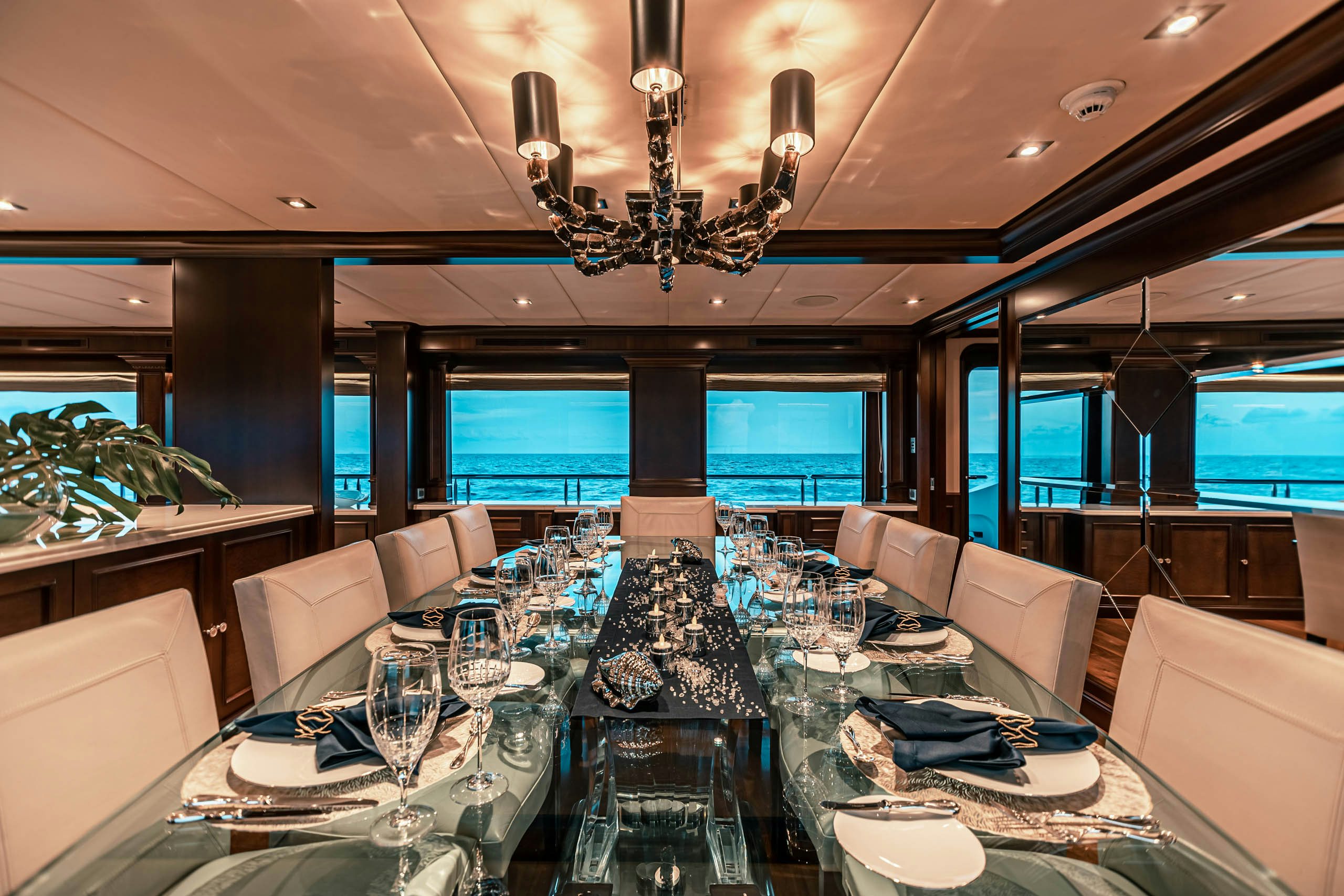 a large dining room with a chandelier aboard MIRABELLA Yacht for Charter