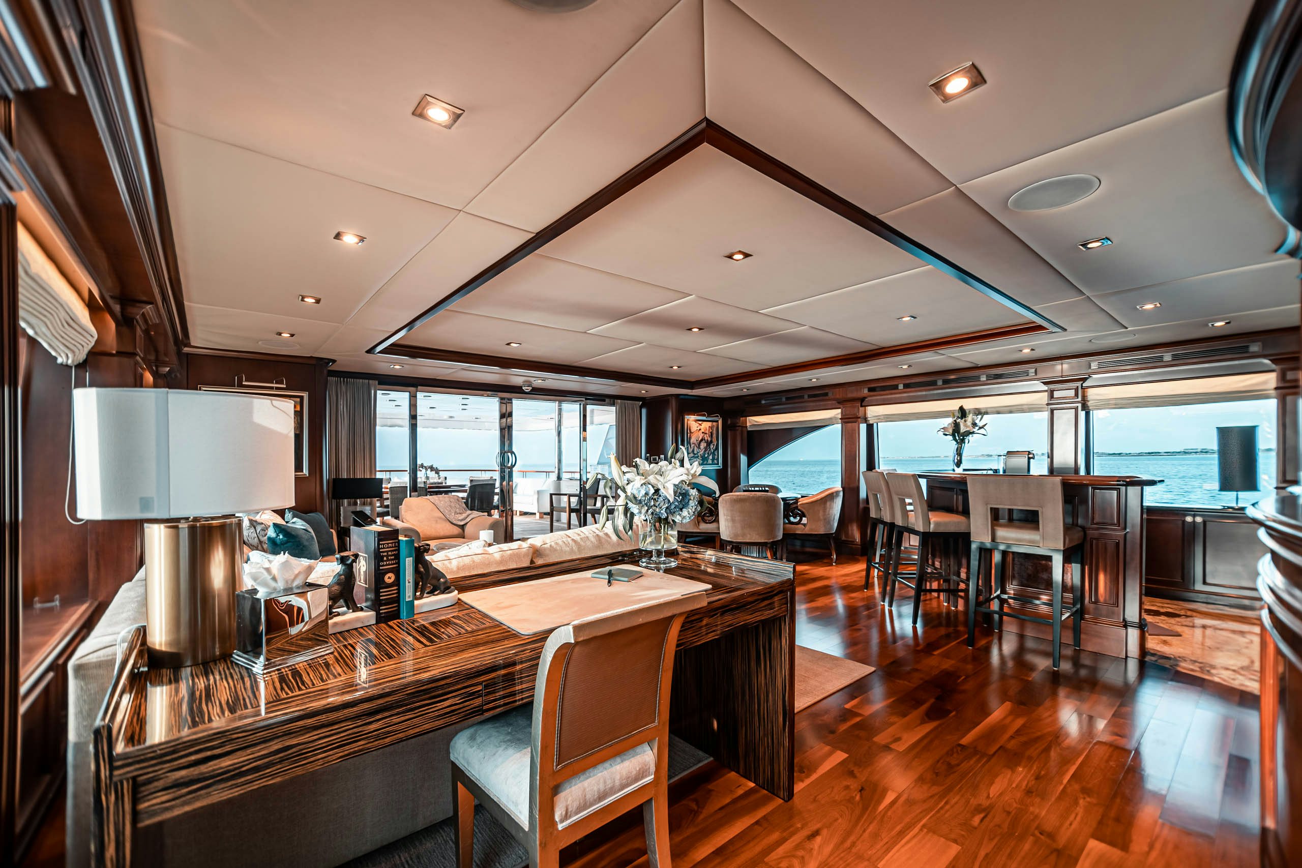 a large room with a wood table and chairs aboard MIRABELLA Yacht for Charter