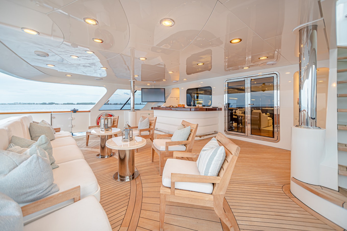 a room with a table chairs and a couch aboard MIRABELLA Yacht for Sale