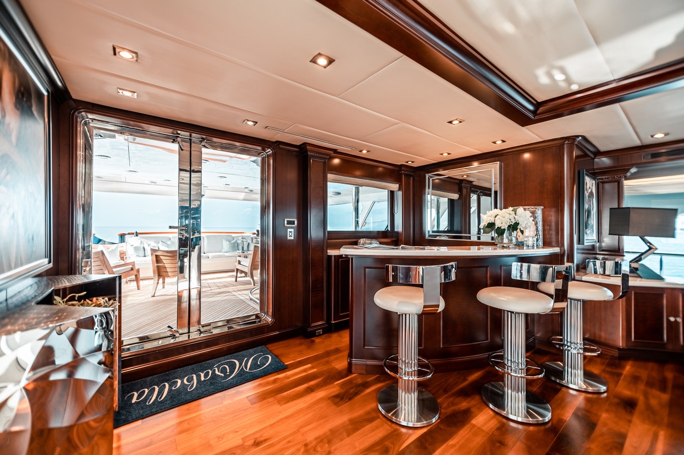 a modern kitchen with a bar and bar area aboard MIRABELLA Yacht for Sale