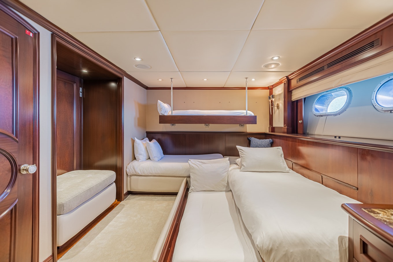 a room with a bed and a window aboard MIRABELLA Yacht for Sale