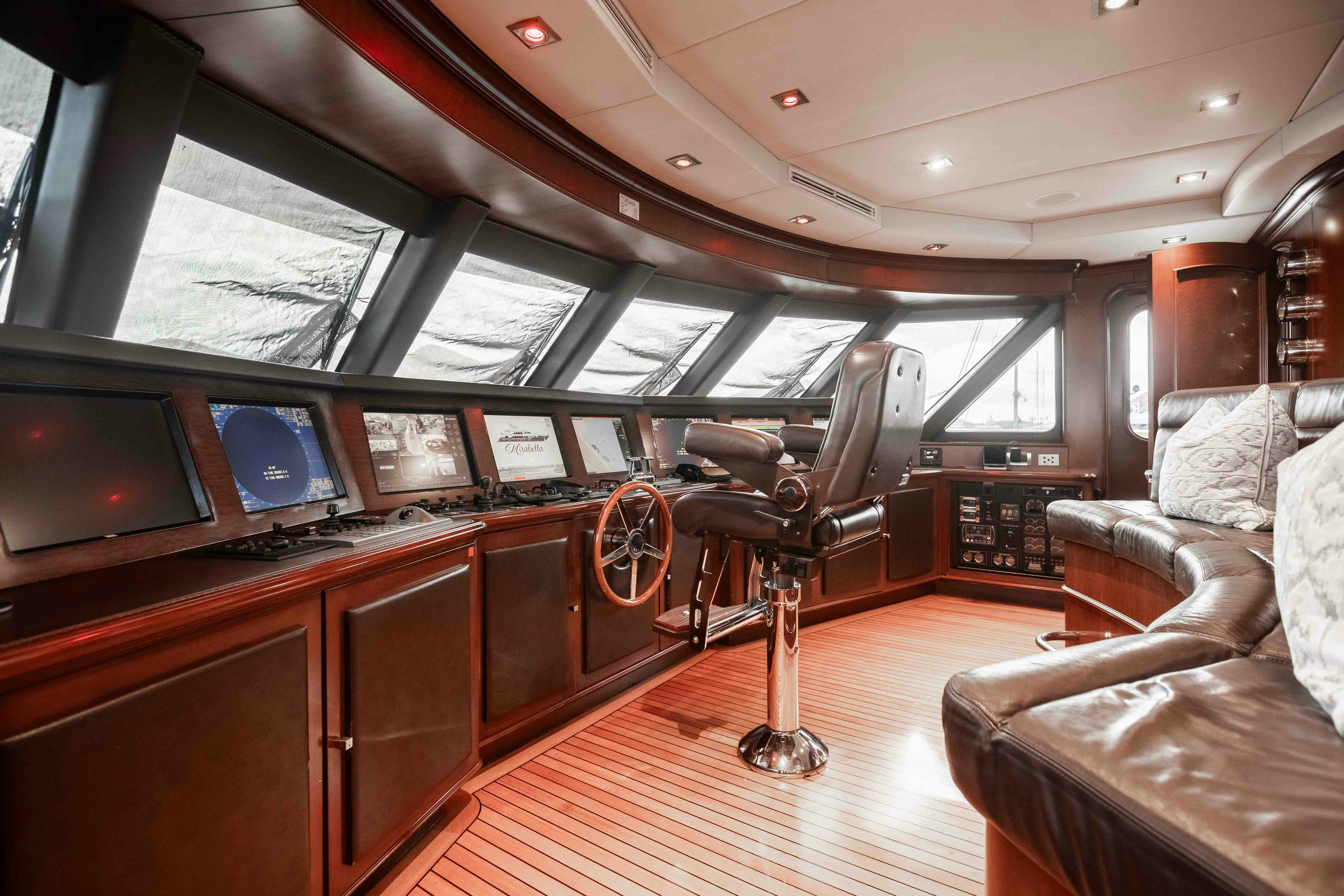 a room with a couch and a television on the wall aboard MIRABELLA Yacht for Sale