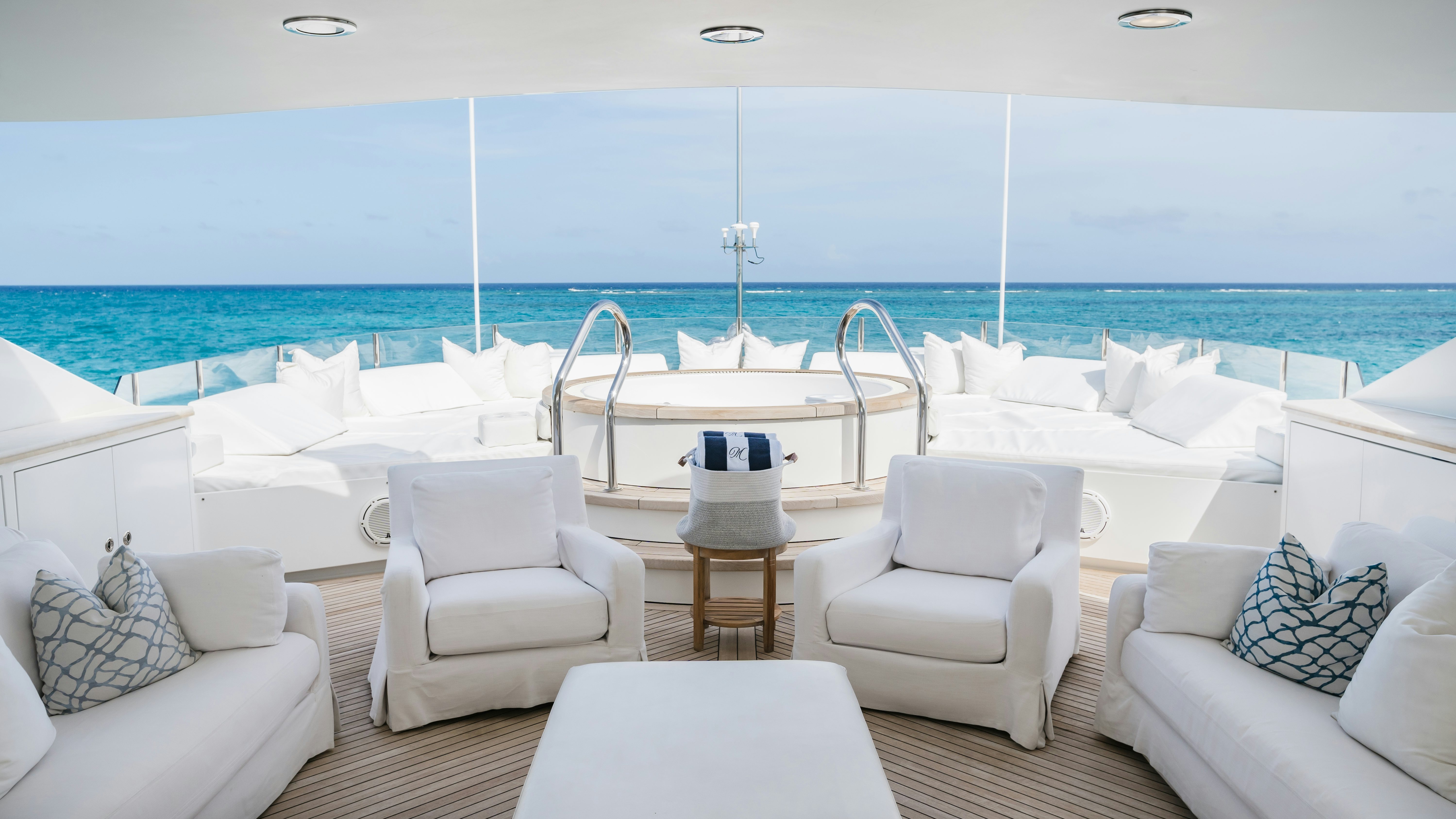 a white lounge chair on a deck overlooking the ocean aboard MIRABELLA Yacht for Sale