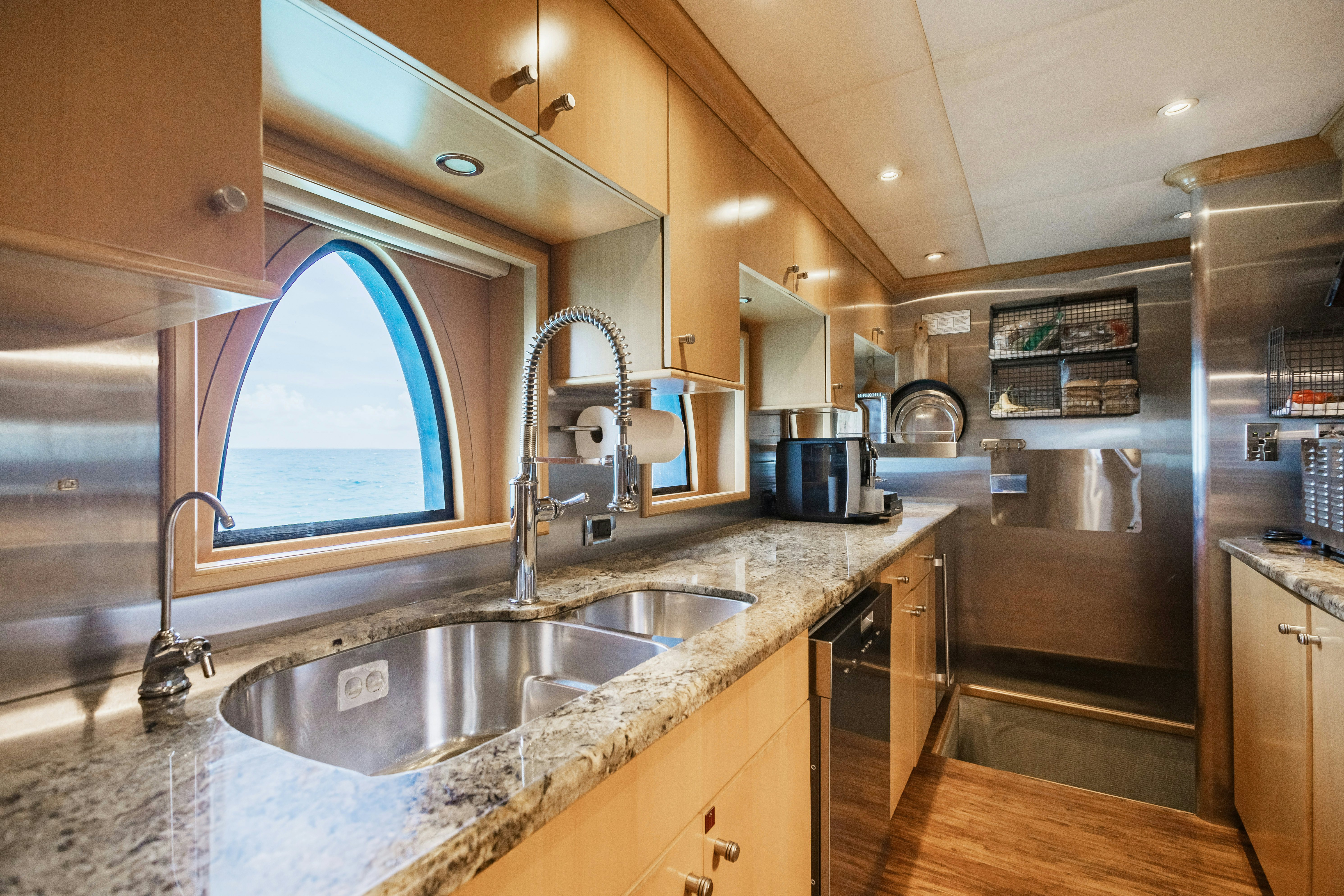 a kitchen with a sink and a microwave aboard MIRABELLA Yacht for Sale