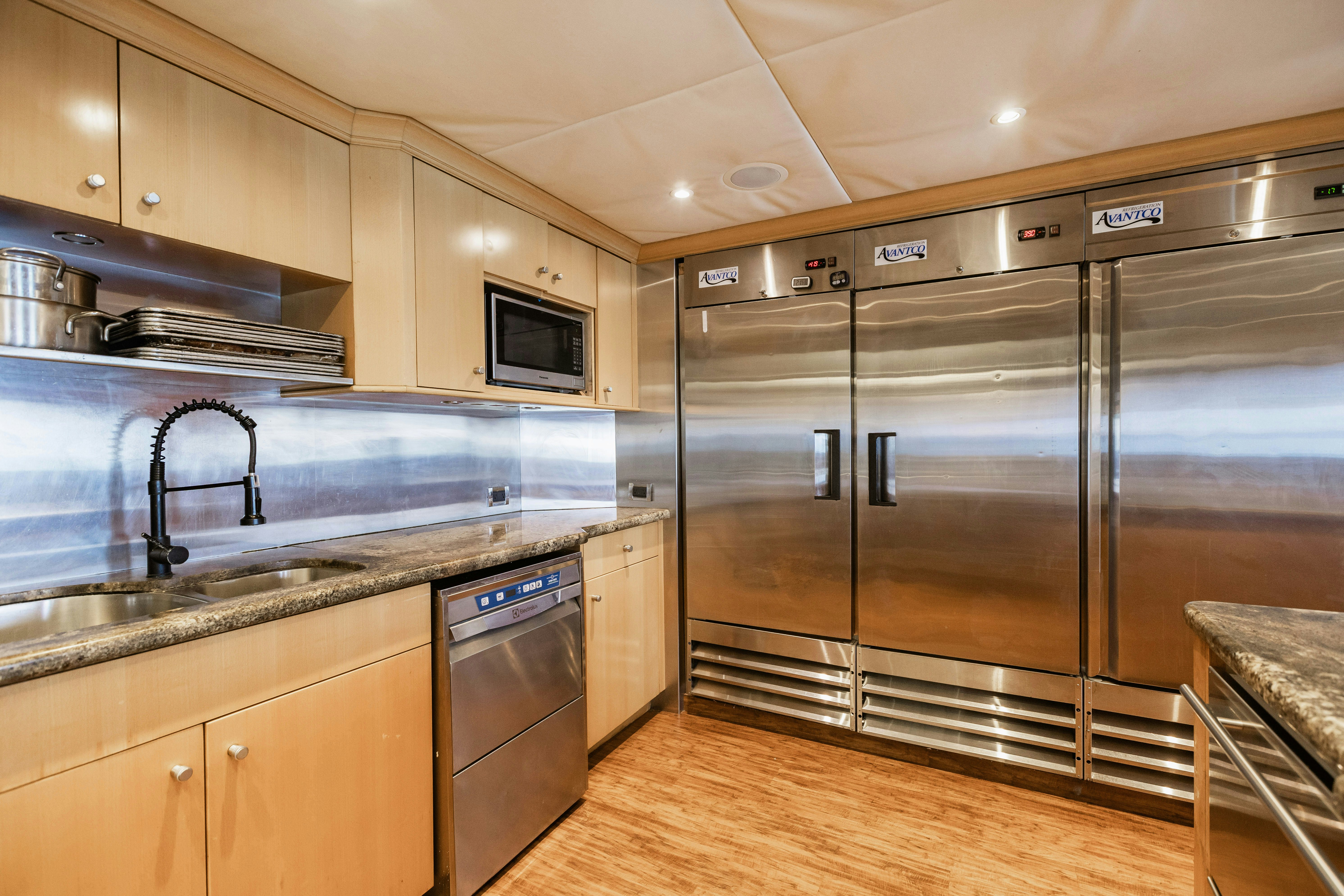 a kitchen with stainless steel appliances aboard MIRABELLA Yacht for Sale