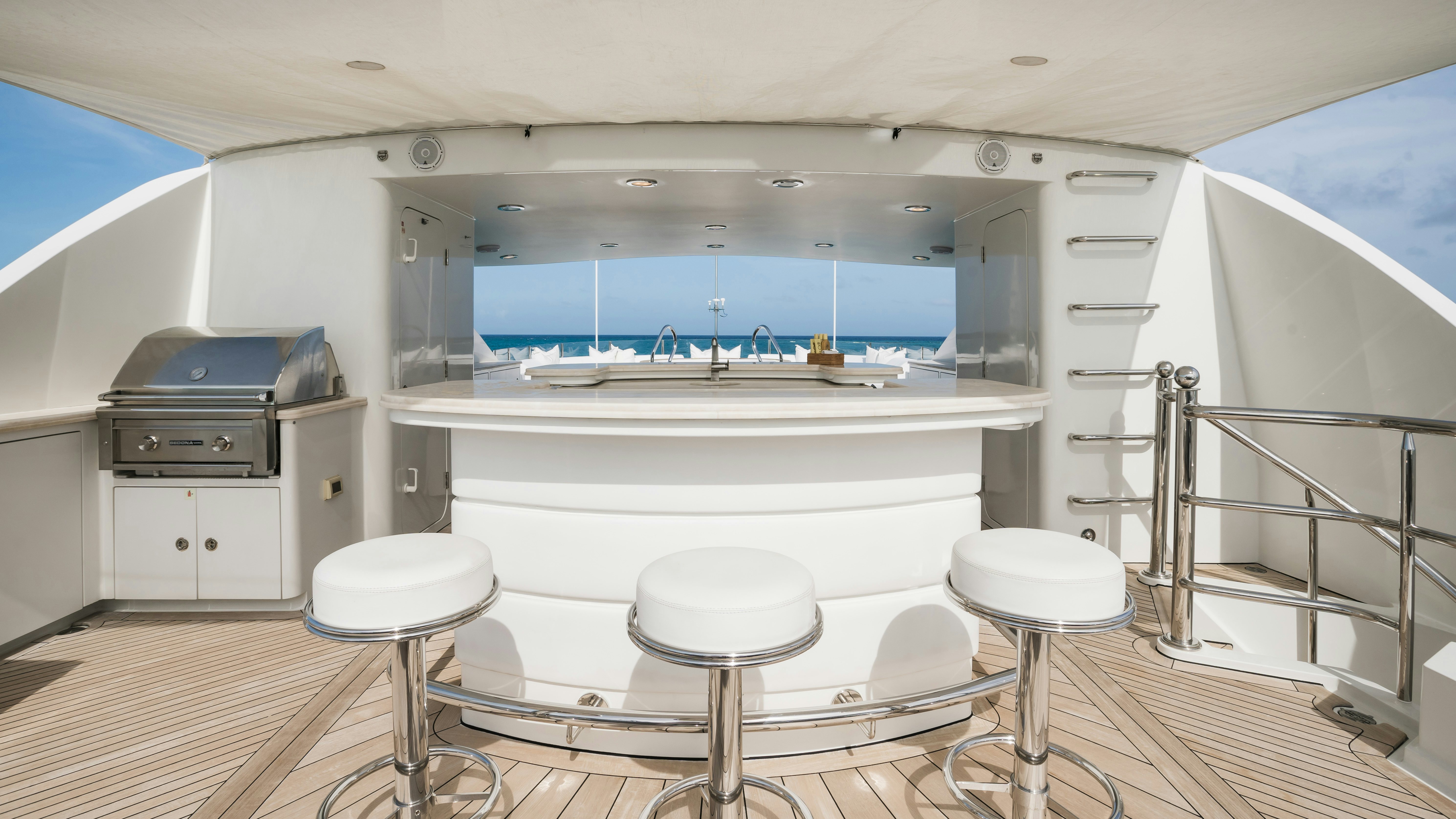 a large white bathroom with stools and a large tub aboard MIRABELLA Yacht for Sale