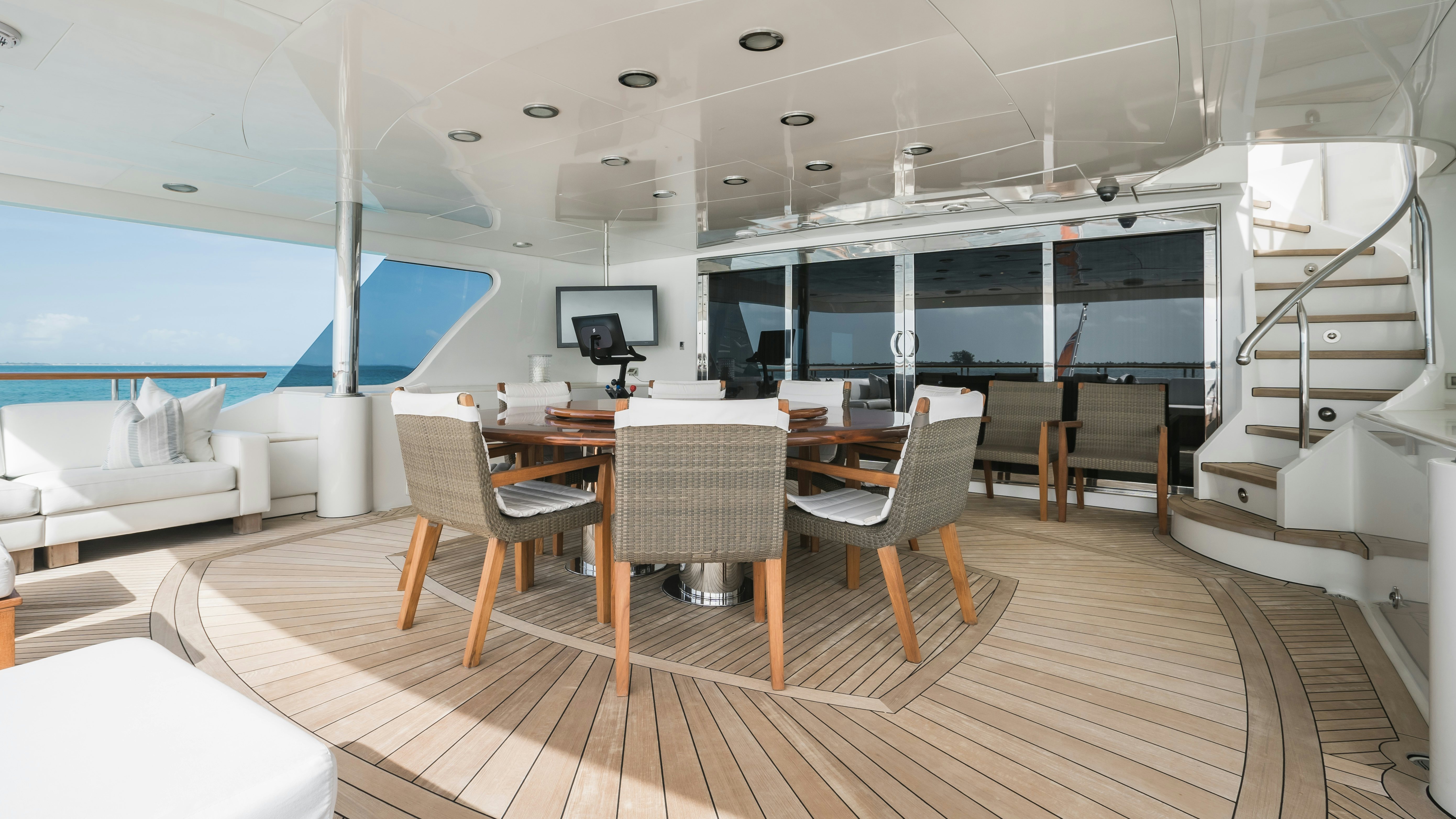 a room with a table chairs and a staircase aboard MIRABELLA Yacht for Sale