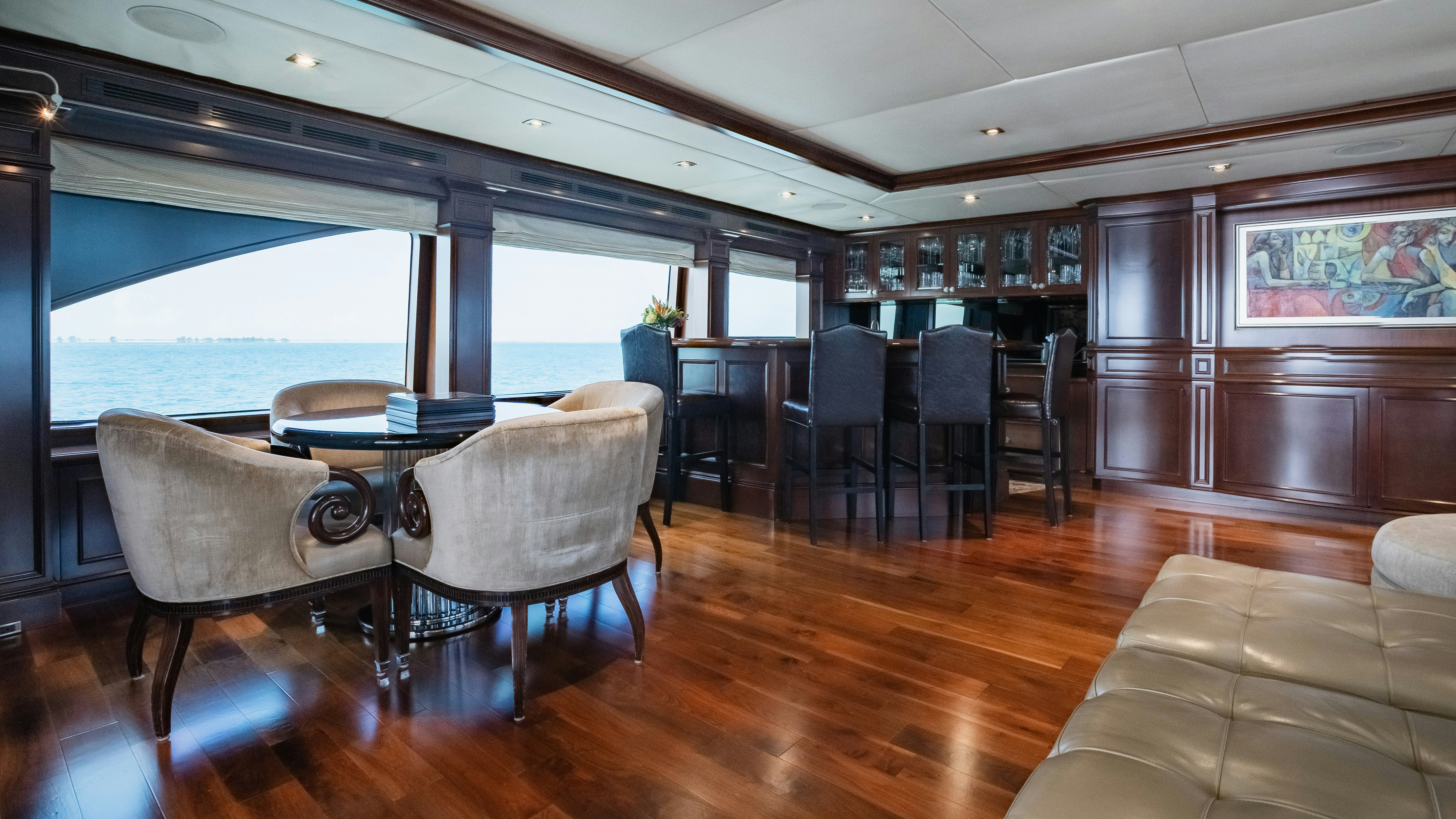 a room with a table chairs and a large window aboard MIRABELLA Yacht for Sale