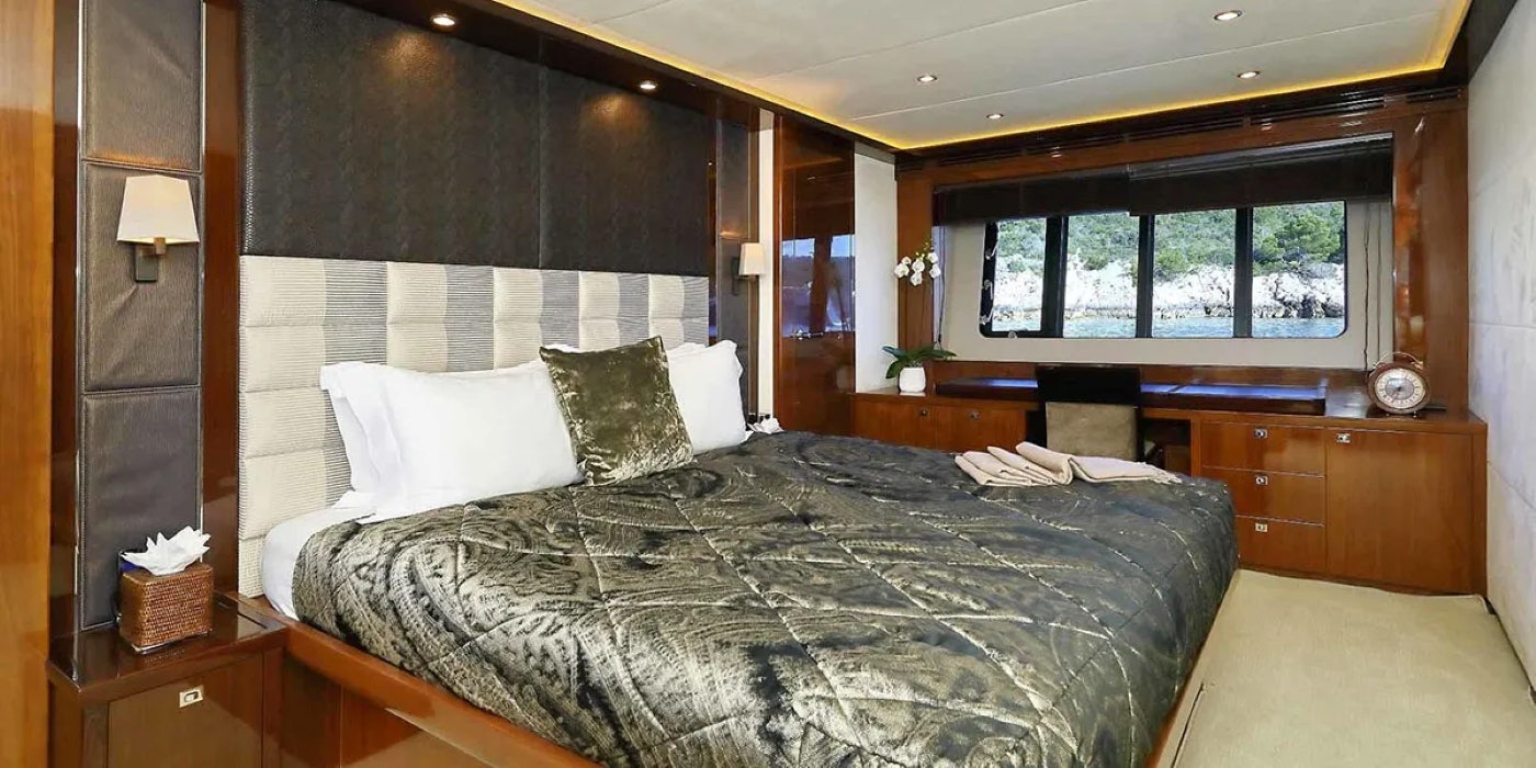 a bed with white pillows aboard AGAVE Yacht for Sale