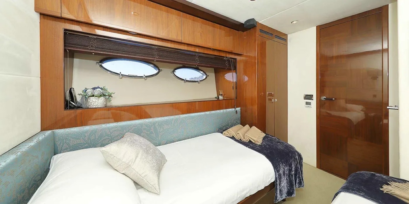 a bed with a white bed spread aboard AGAVE Yacht for Sale