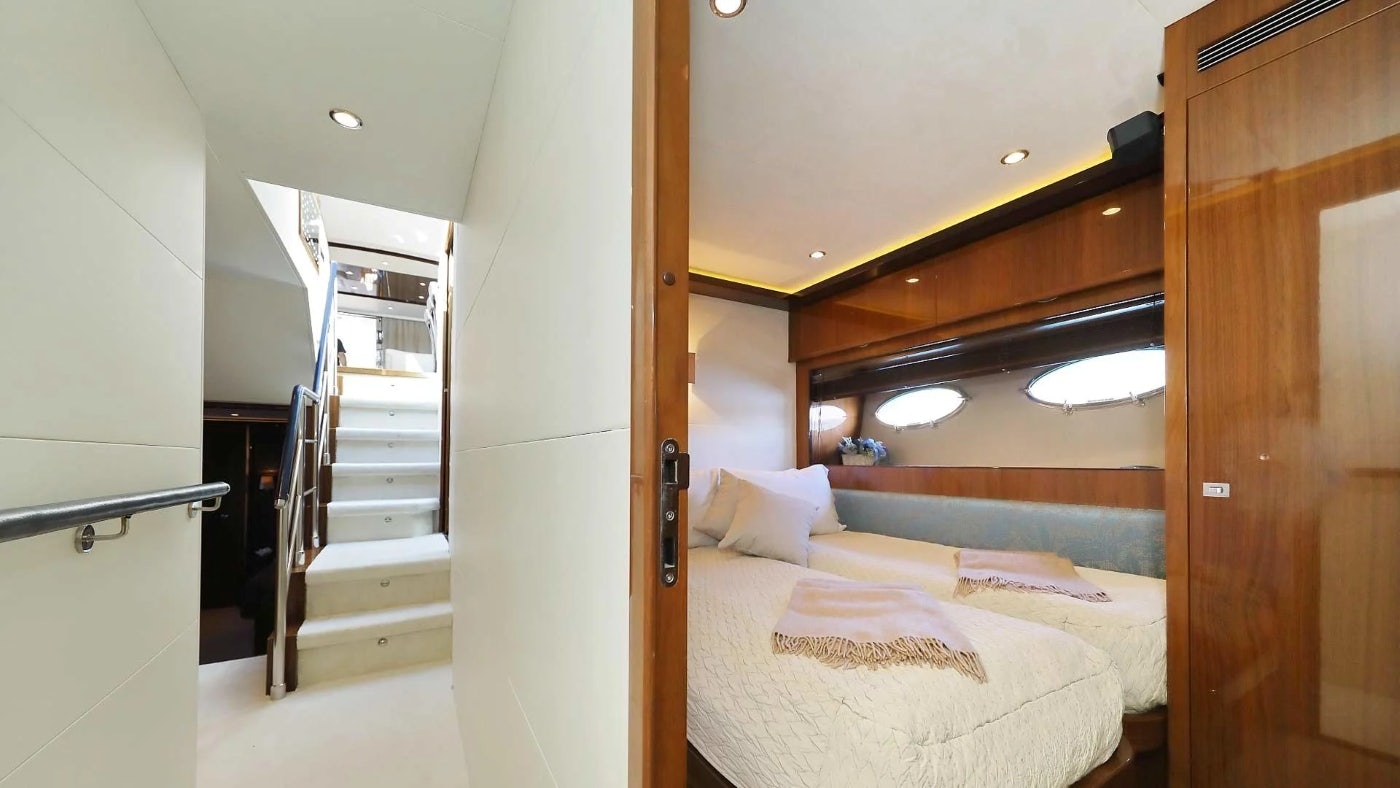 a bedroom with a bed and a staircase aboard AGAVE Yacht for Sale