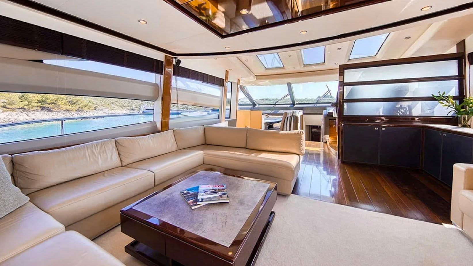 a living room with a couch and a coffee table aboard AGAVE Yacht for Sale