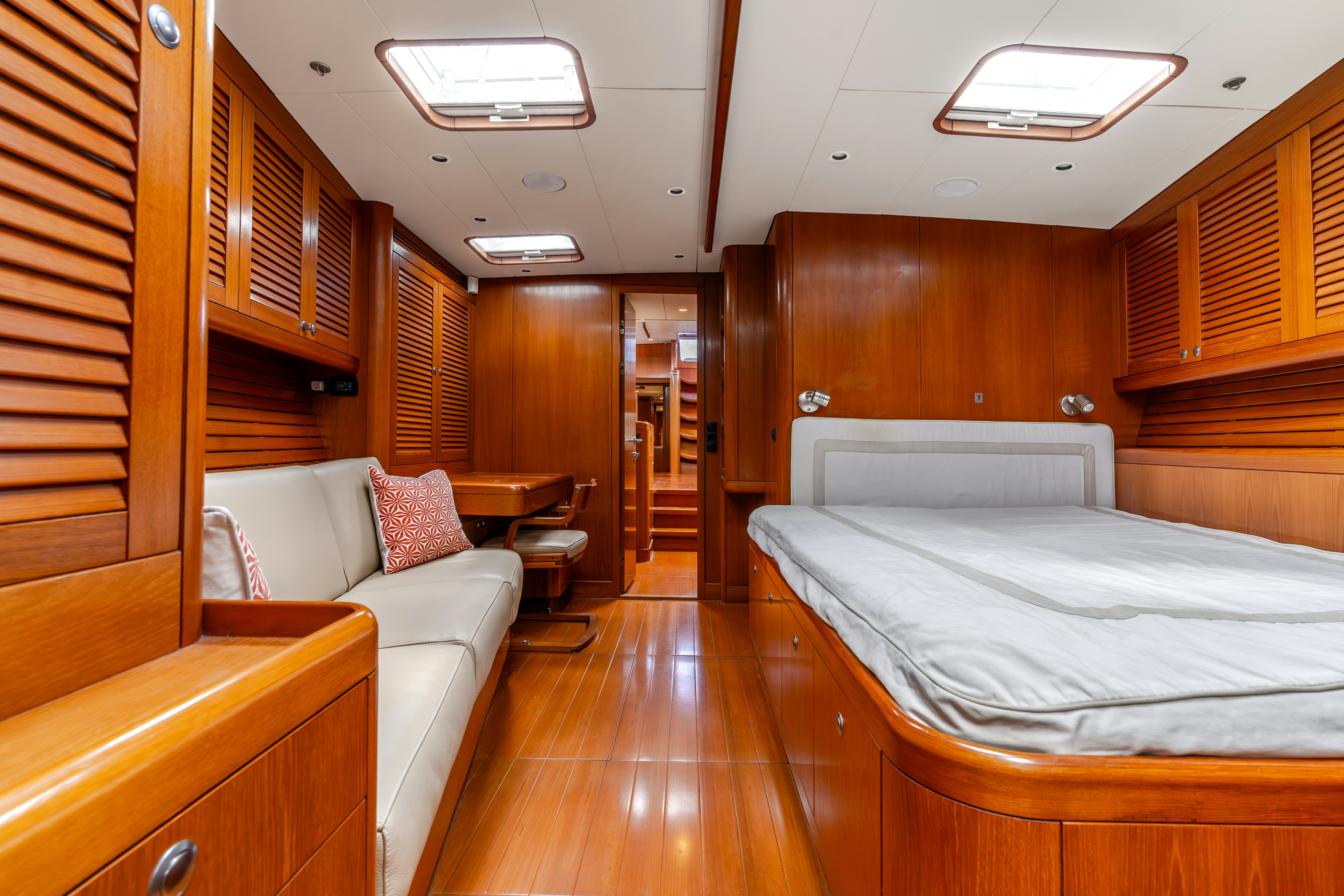 a bedroom with a bed and a couch aboard WHITE RHINO Yacht for Sale